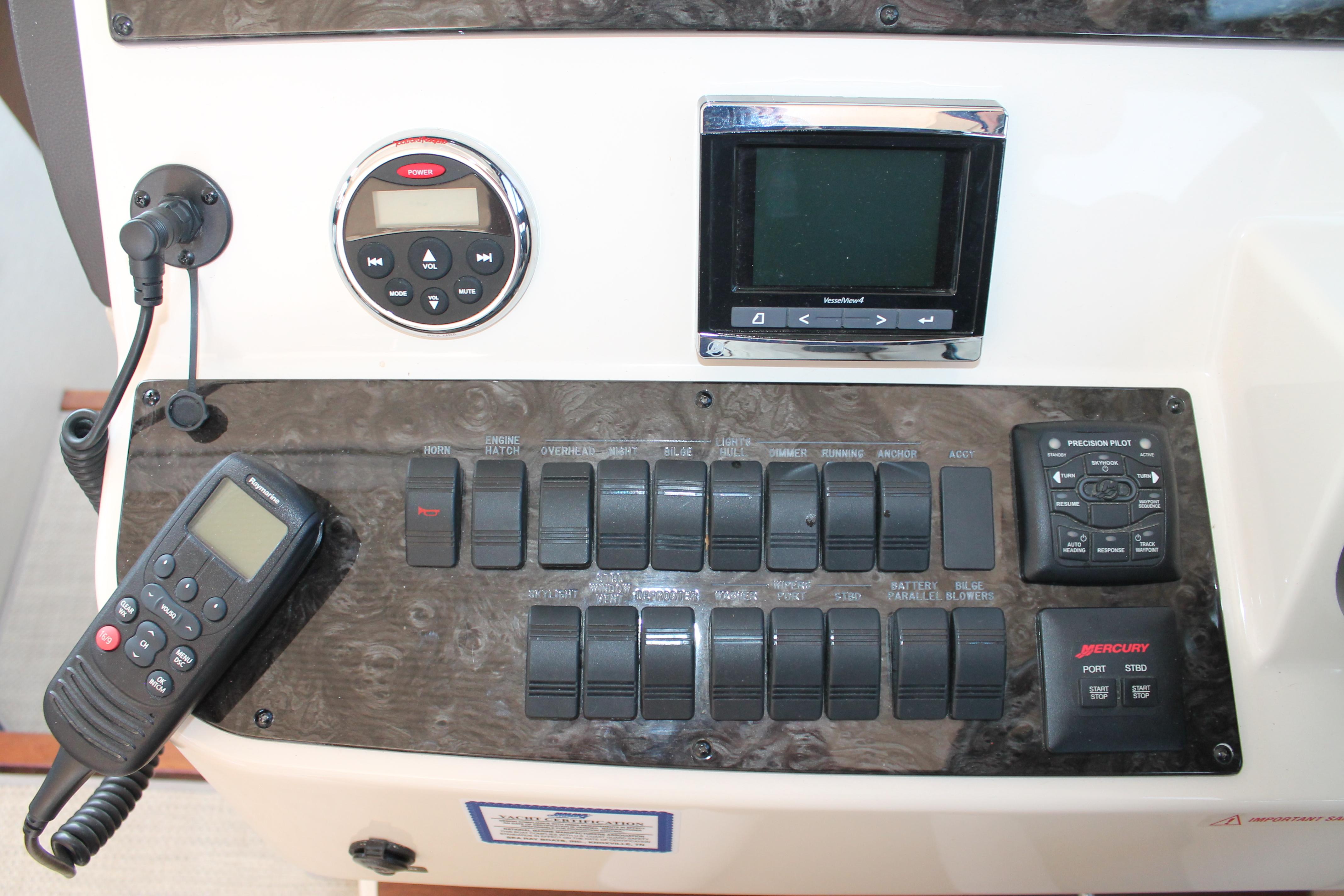 Control panel of 2015 Sea Ray 470 Sundancer with switches and navigation equipment.