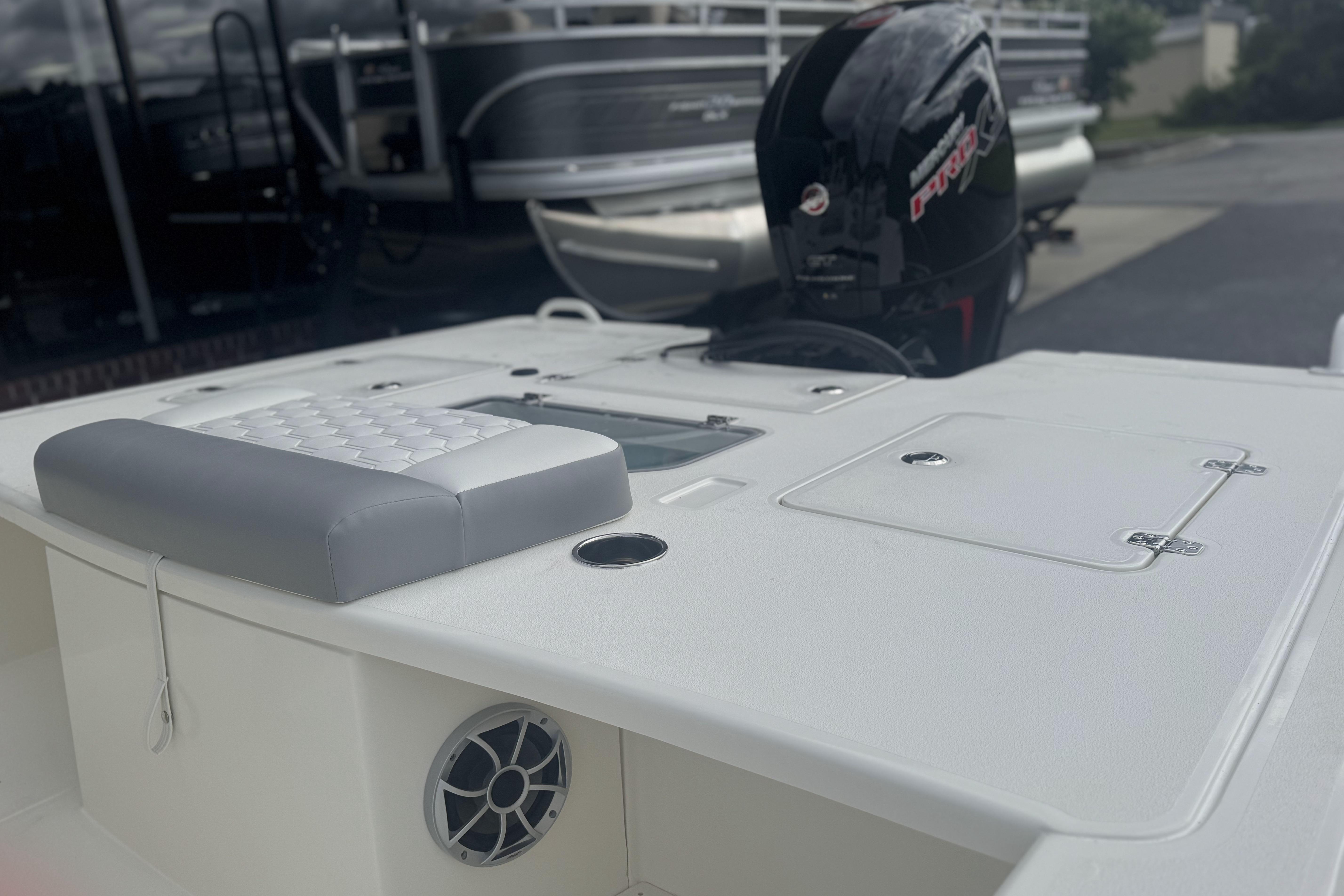 2026 Mako 18 Pro Skiff boat with cushioned seating and outboard motor.