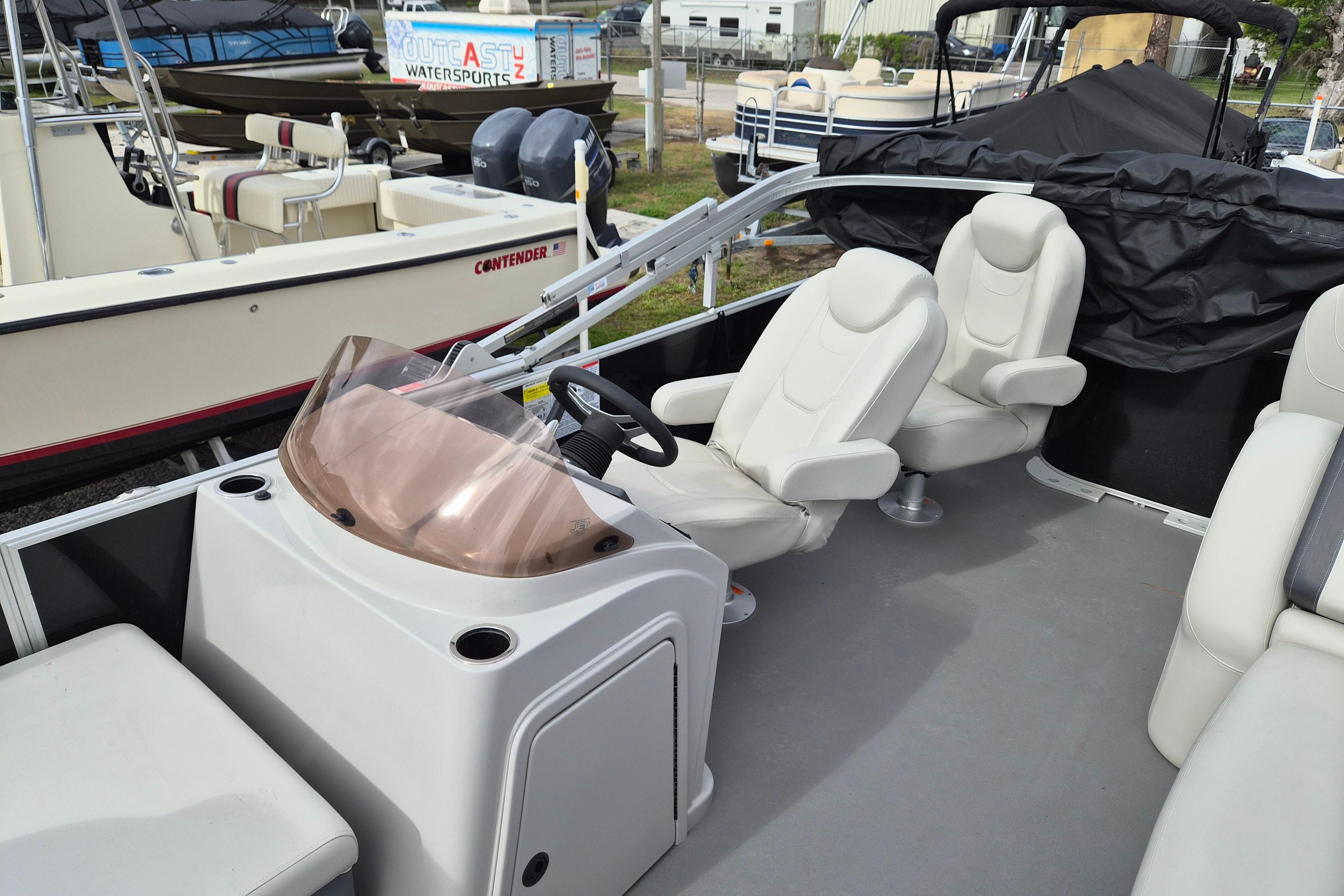 2025 Sylvan Mirage Fish 8522 Party Fish 4.0 interior with comfortable seating and steering console.