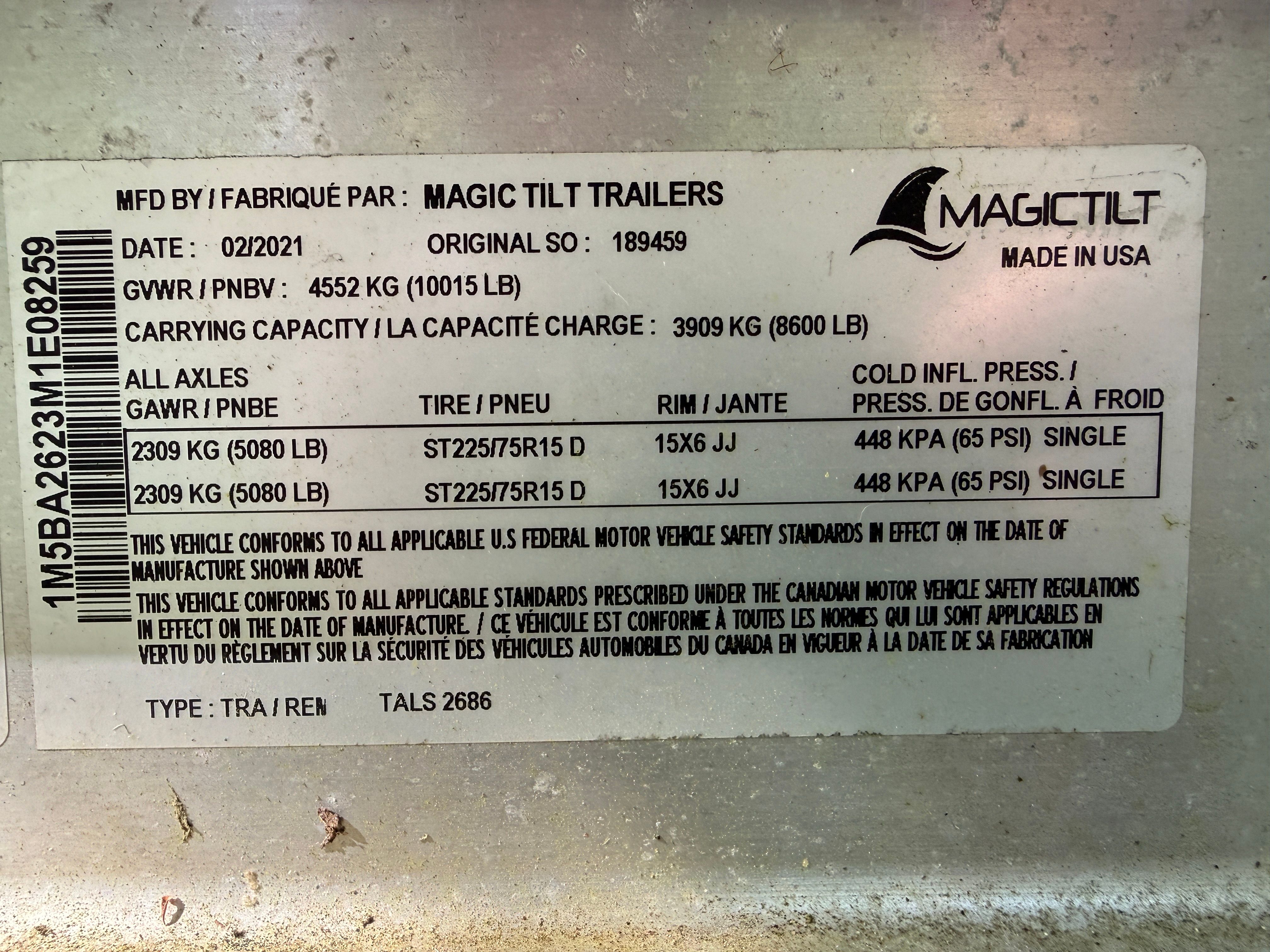 A Magic Tilt Trailers label with technical specifications and safety information.
