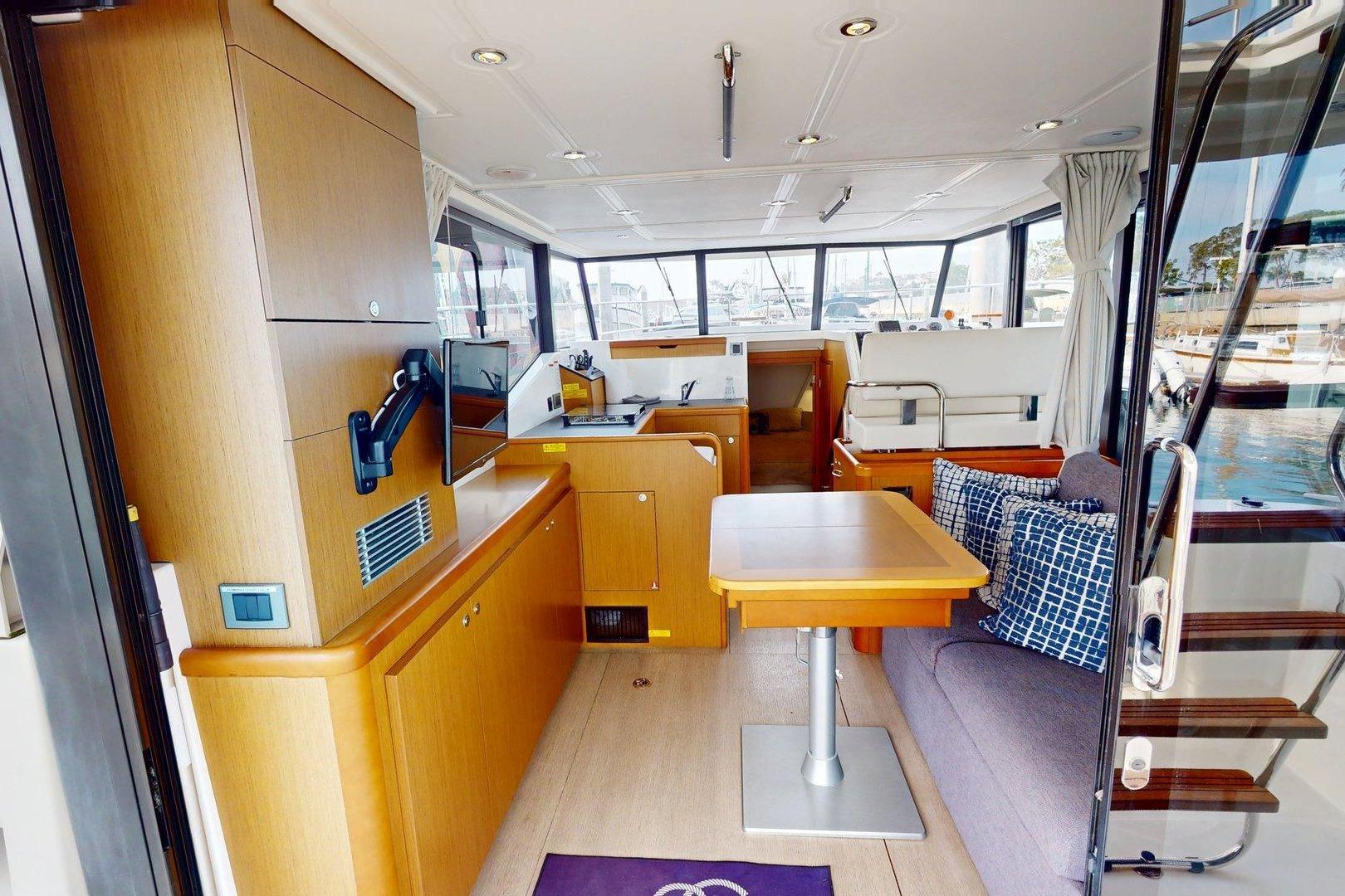 Interior of 2021 Beneteau Swift Trawler 35, featuring modern wood finishes and seating area.