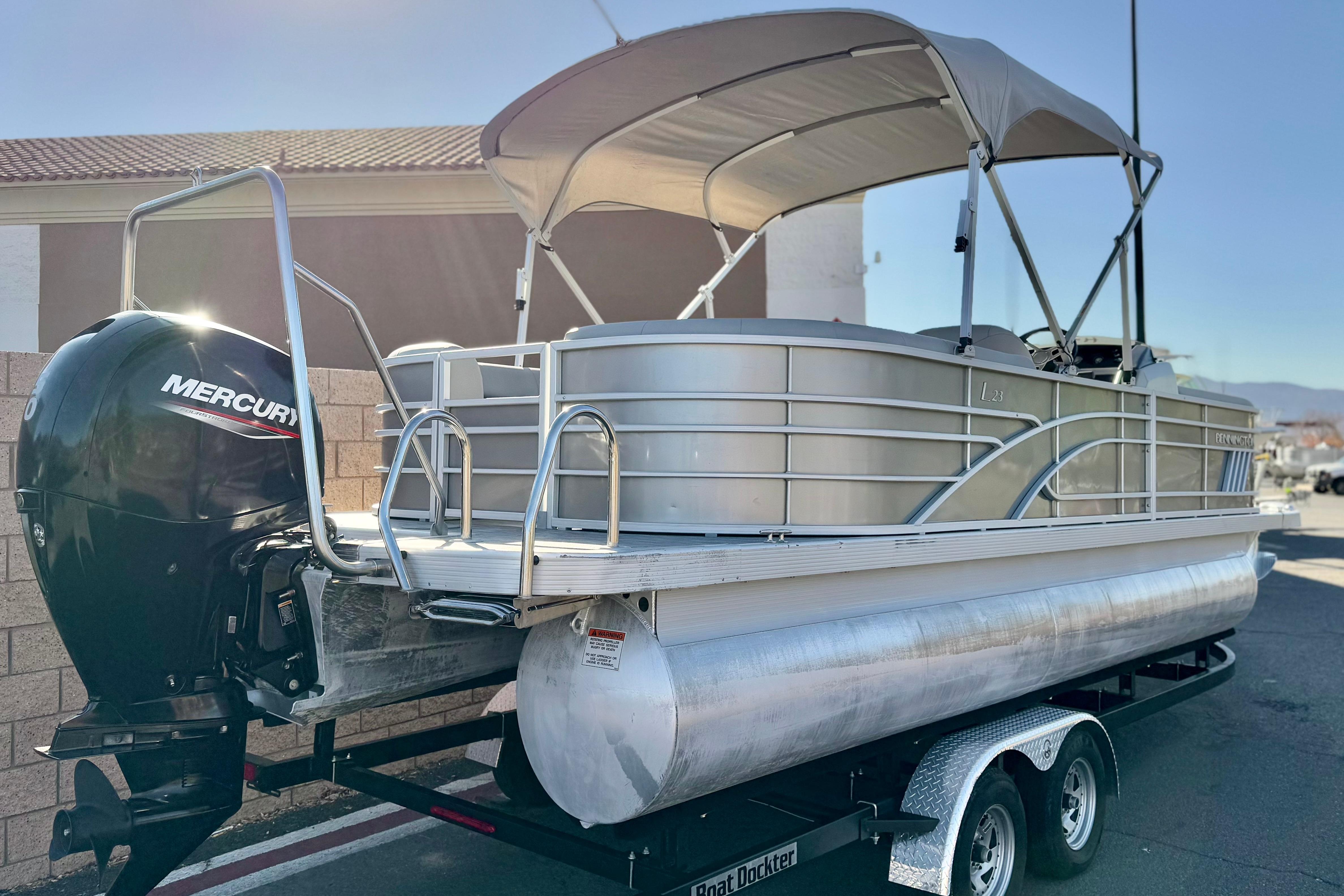 2021 Bennington 23LSR pontoon boat with Mercury outboard engine on trailer.