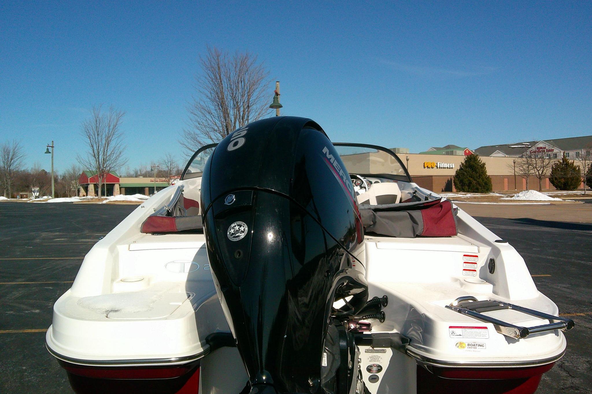 2024 Tahoe 200 S boat with Mercury outboard motor in a parking lot.