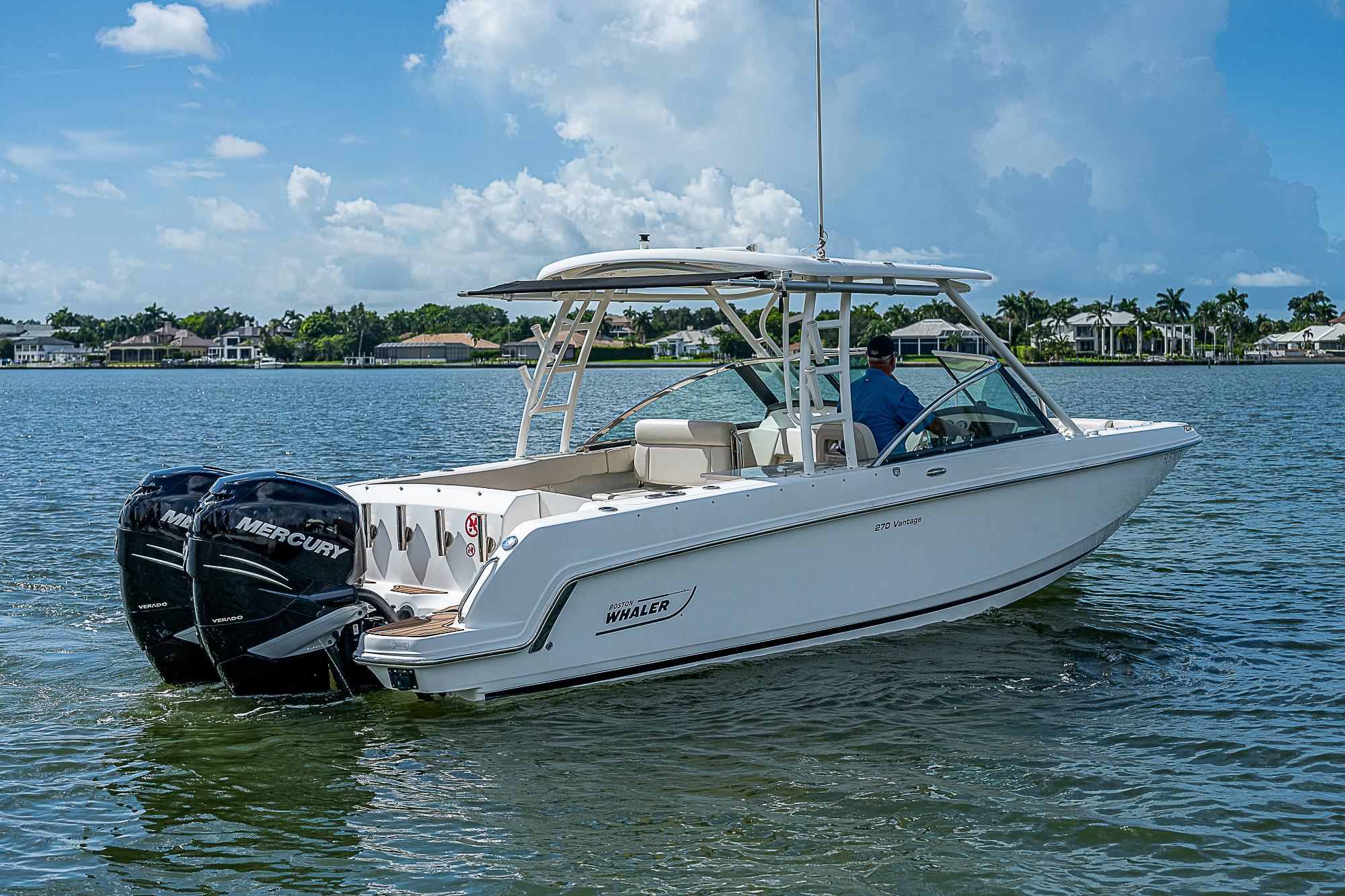 2018 Boston Whaler 270 Vantage boat on calm water, featuring dual Mercury engines.
