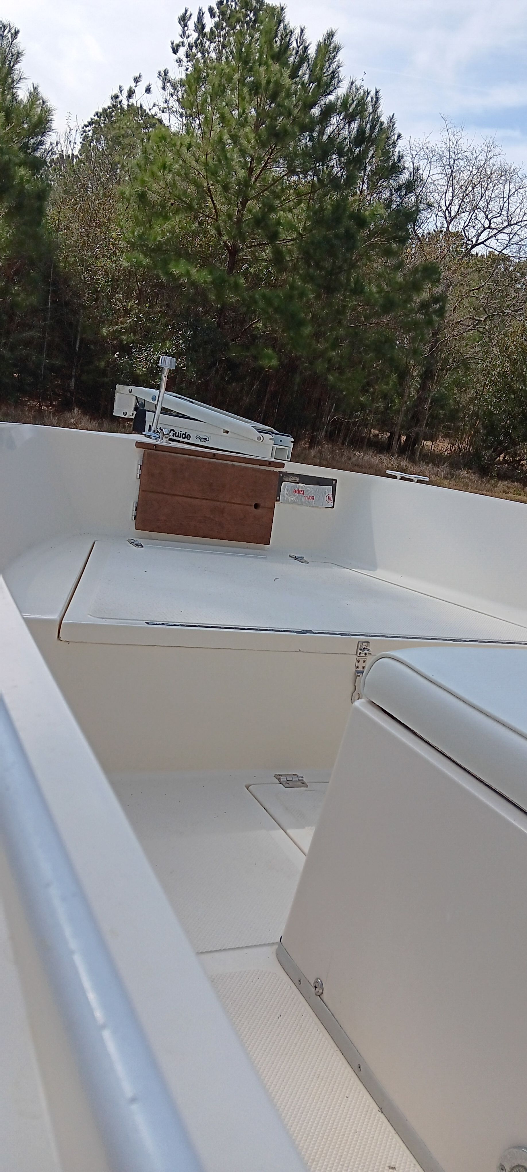 The image shows the deck of a 1990 Hydra-Sports Vector boat, surrounded by trees.