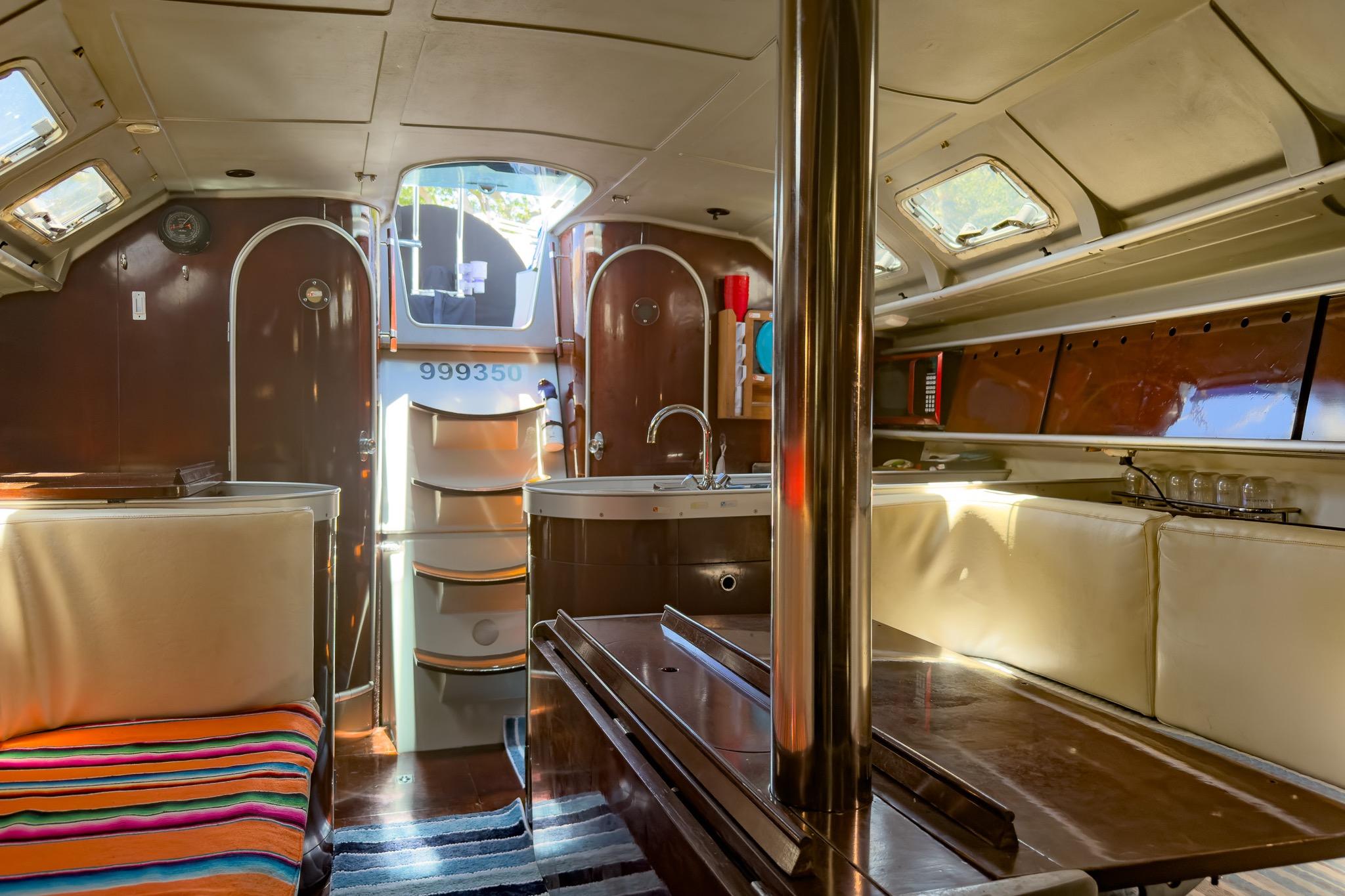 Interior of 1993 Beneteau First 38 s5 yacht, featuring cozy seating and modern amenities.