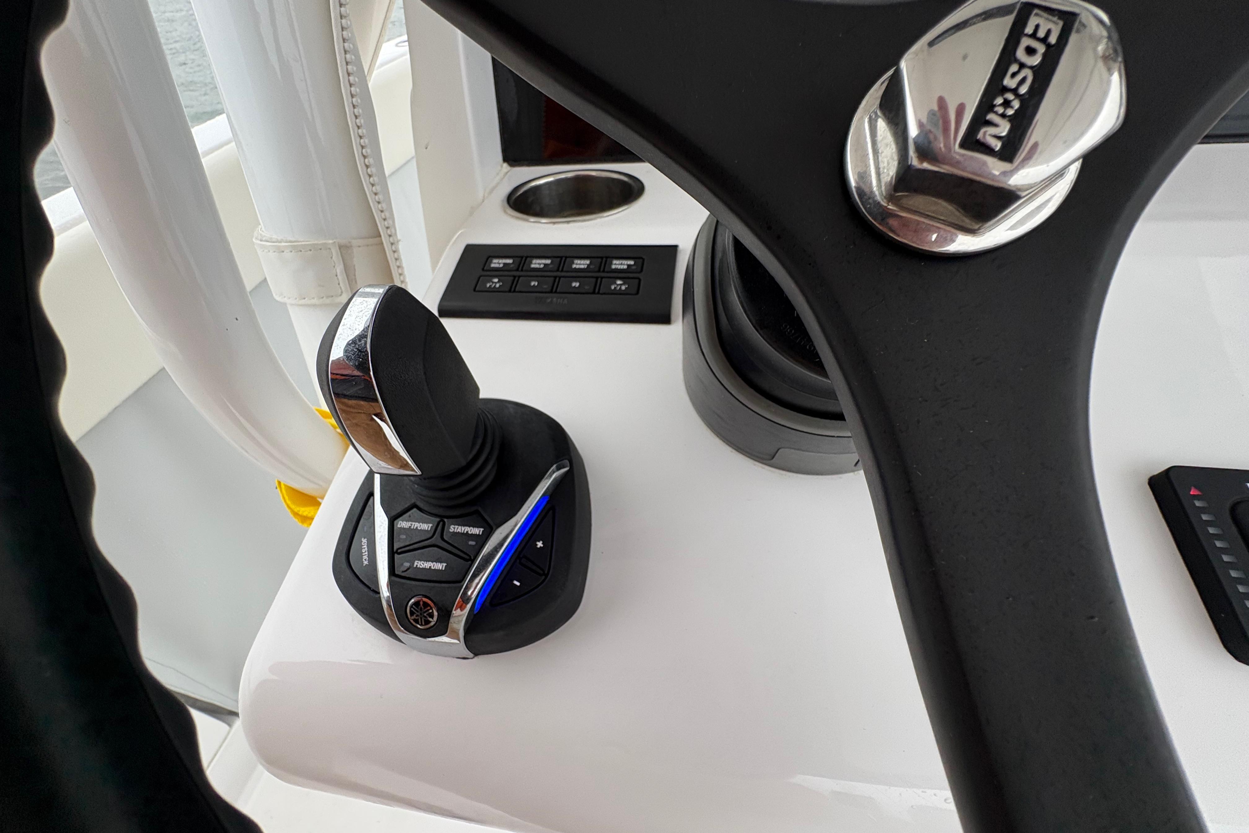 Control panel of 2023 Jupiter 30 boat with joystick and steering wheel.