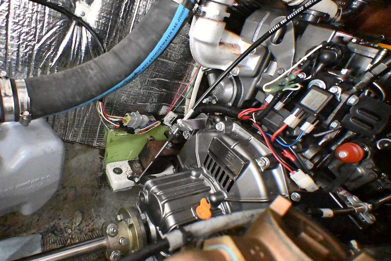 Engine compartment of a 1977 Mercator Offshore boat, showcasing wiring and components.