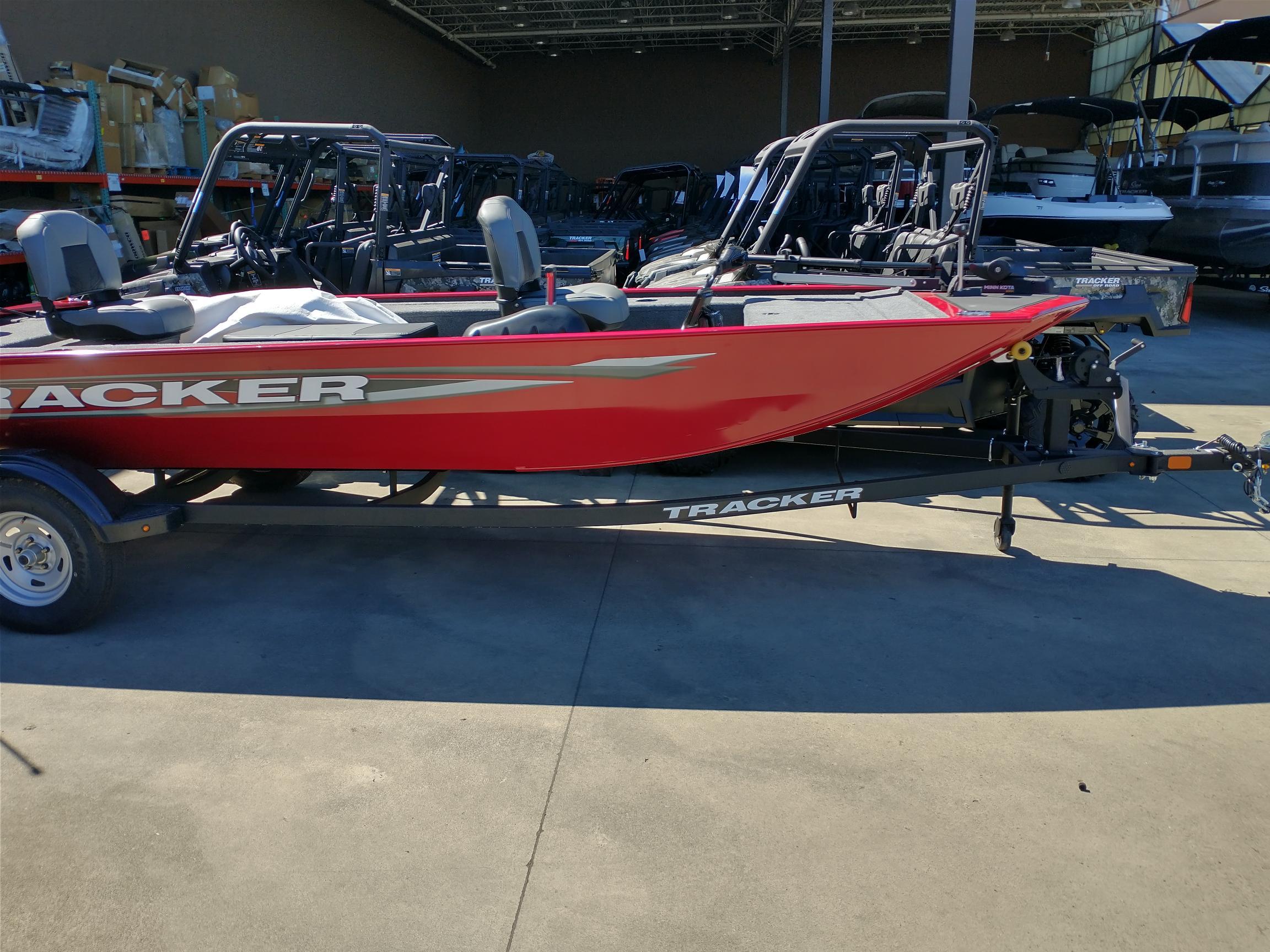 2025 Tracker Panfish 17 boat in showroom, red exterior, on trailer.