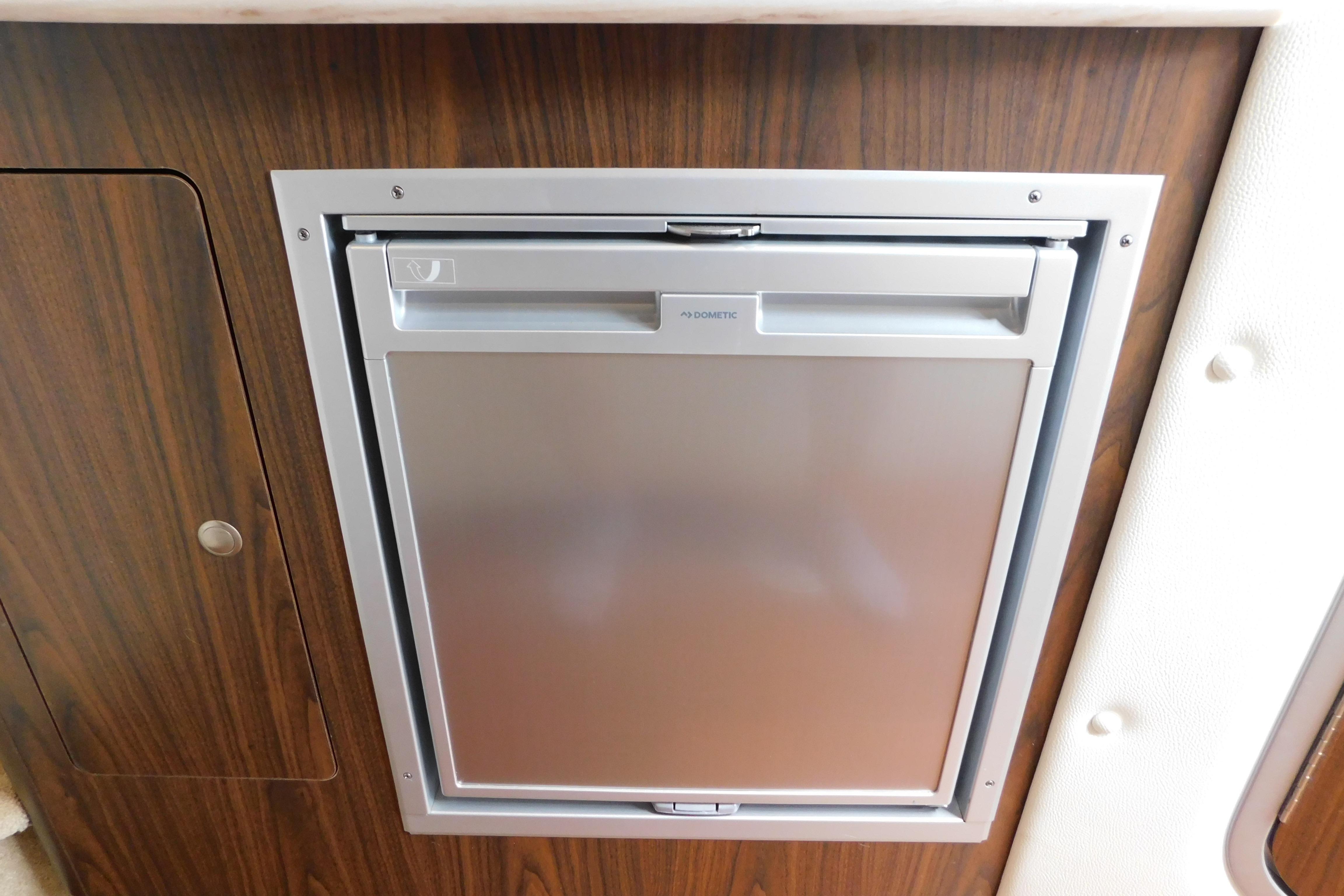 Built-in Dometic refrigerator in 2017 Rinker EX 320 boat interior.
