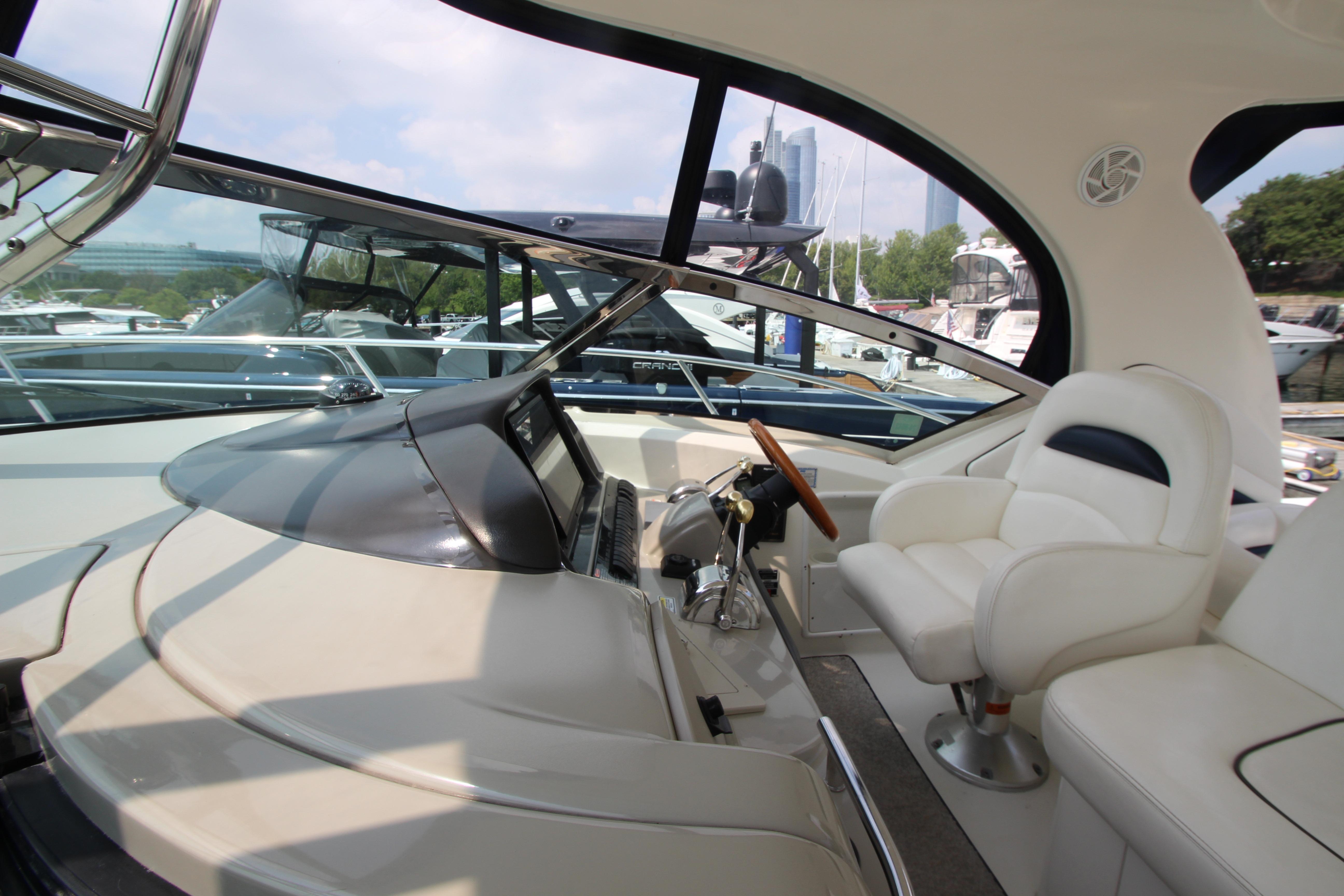 2004 Sea Ray 40 Sundancer yacht interior with helm and seating area.