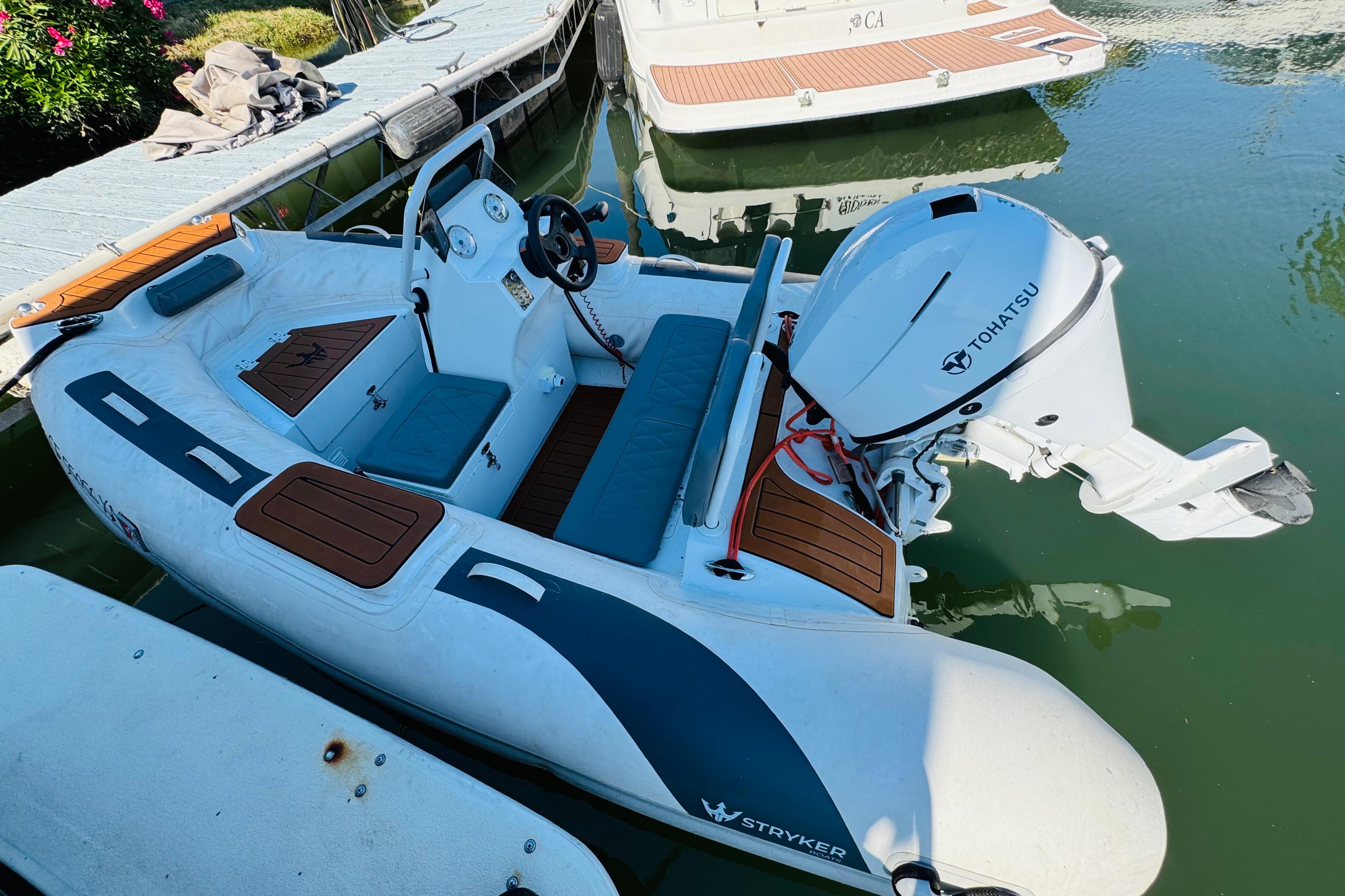 A Nordic Tug 32 boat from 1996 docked, featuring a Tohatsu outboard motor.