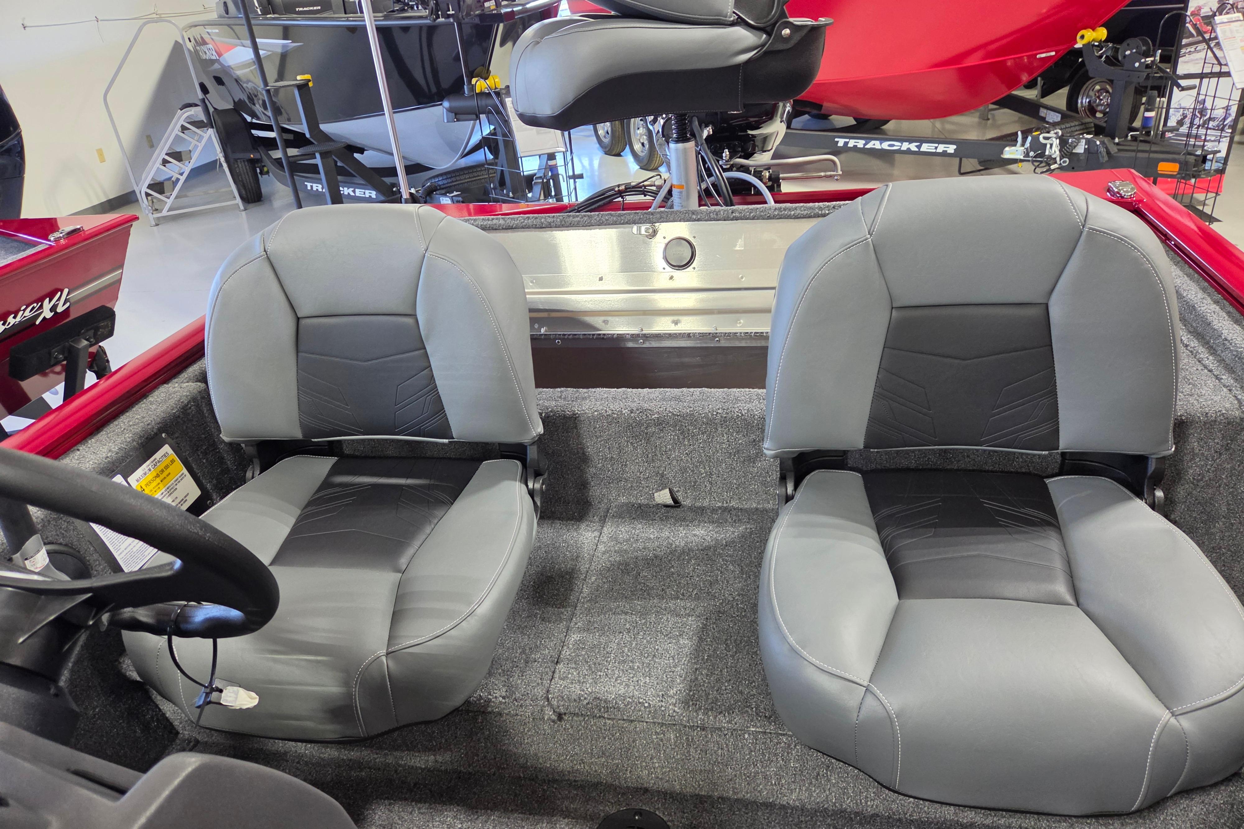 2026 Tracker Pro 170 boat interior with two gray seats in showroom.