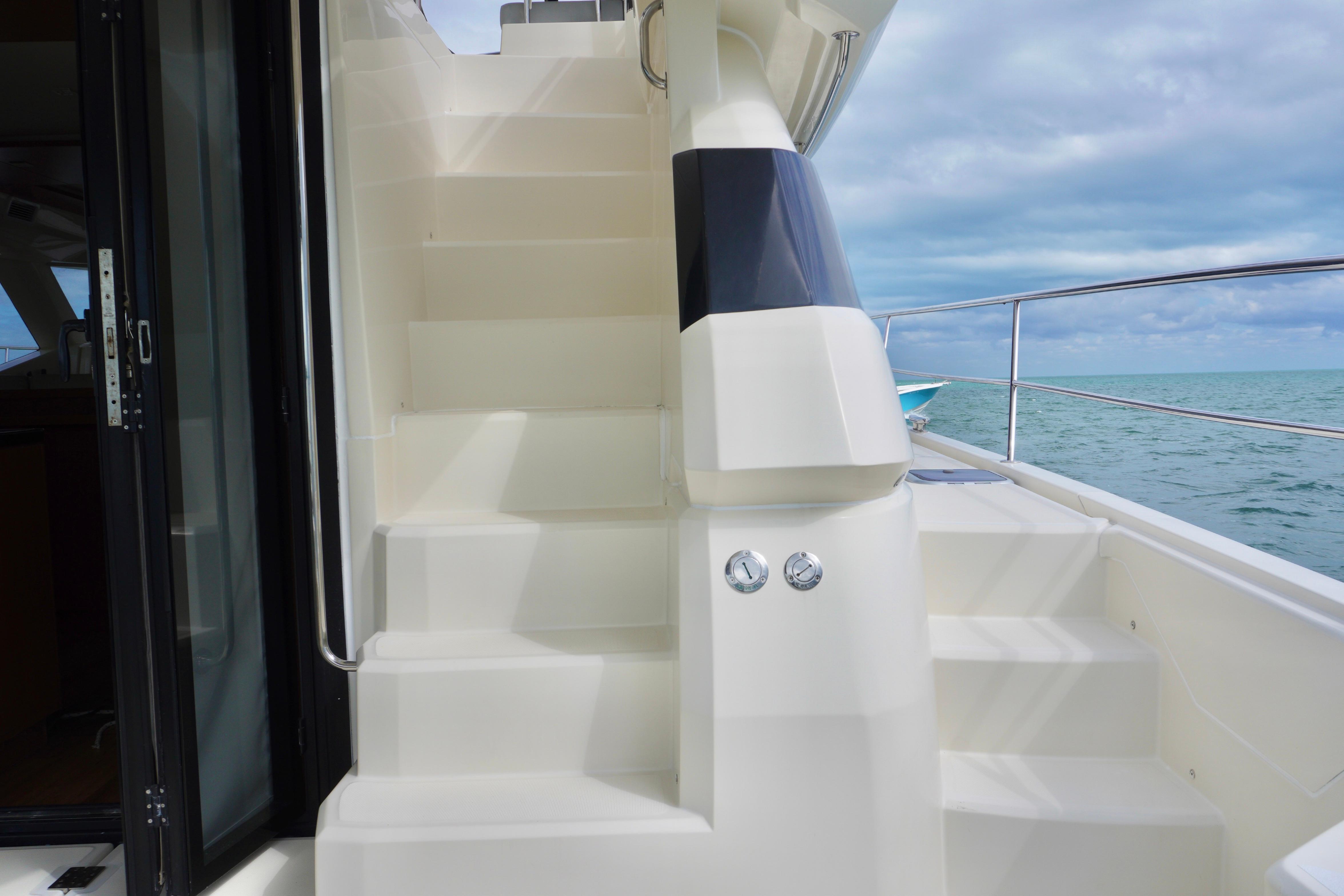 Staircase on 2017 Aquila 44 Yacht with ocean view in background.