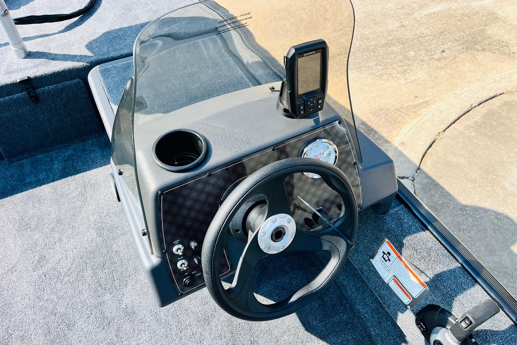 2026 Tracker Bass Tracker Classic XL boat dashboard with steering wheel and navigation system.