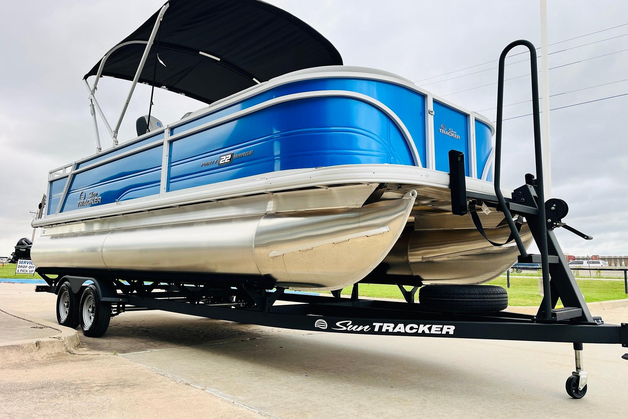 2026 Sun Tracker Party Barge 22 RF DLX pontoon boat on trailer, side view.