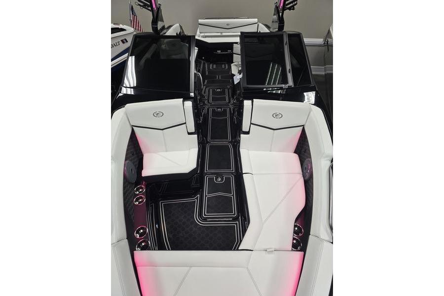 2026 Cobalt R8 Surf boat interior with sleek black and white seating and ambient lighting.