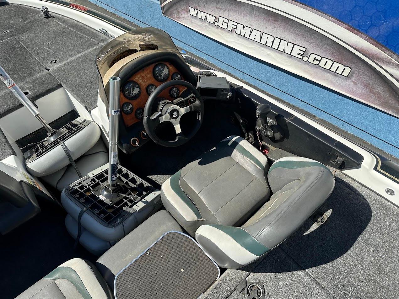 1999 Fisher 21 FX DC boat interior with steering wheel and seating.