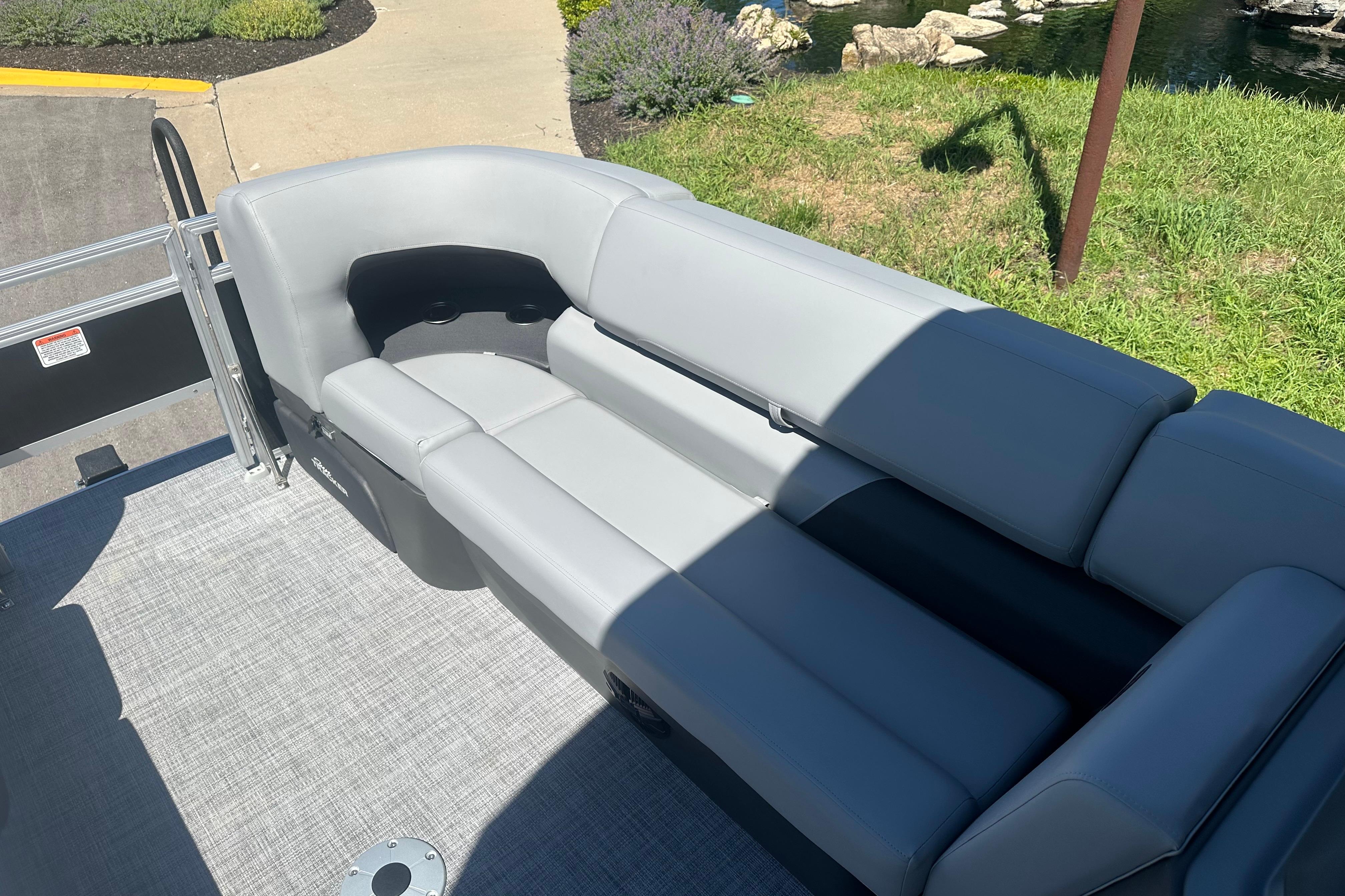2026 Sun Tracker SportFish 22 DLX boat with sleek gray seating and spacious deck.