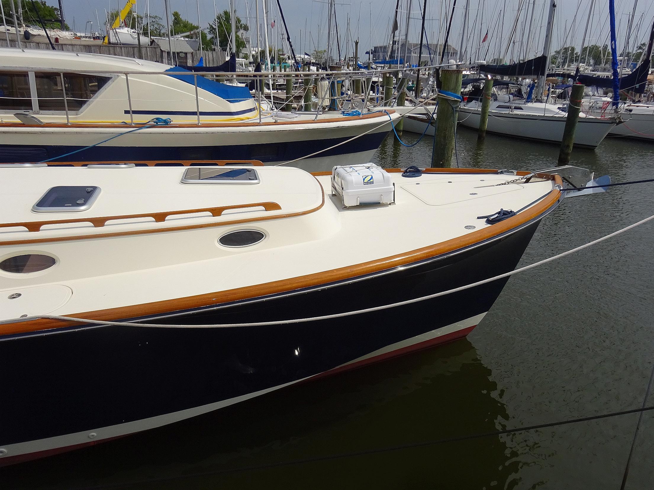 2002 Hinckley Talaria 44 FB yacht docked in marina, featuring sleek design and classic styling.