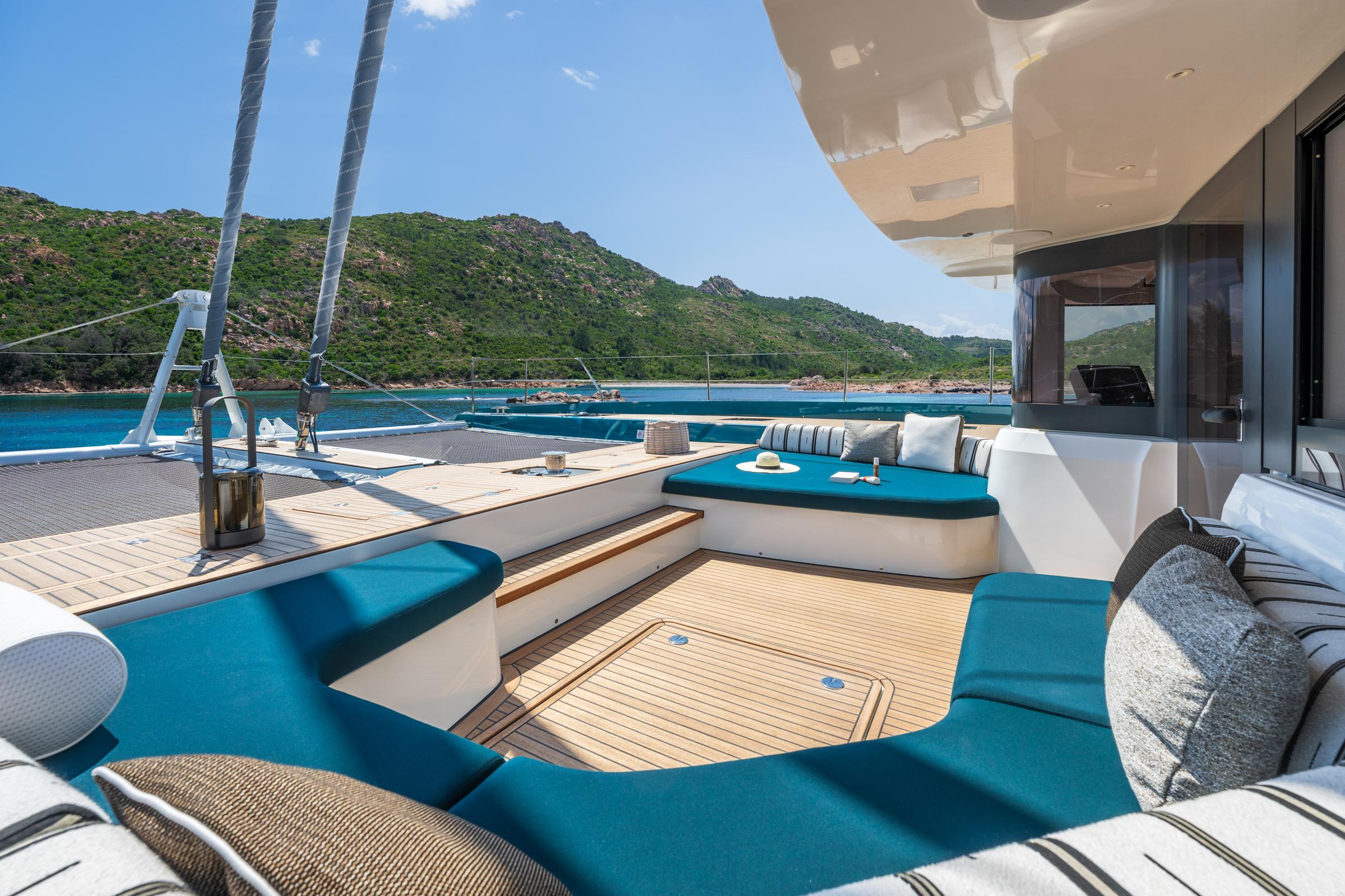 Luxurious Lagoon Eighty 2 yacht deck with plush seating, scenic ocean view, 2025 model.