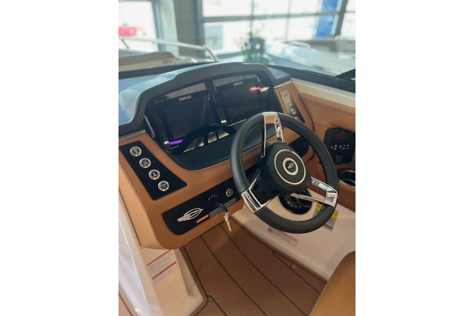 2025 Chaparral 247 SSX boat dashboard with steering wheel and digital displays.