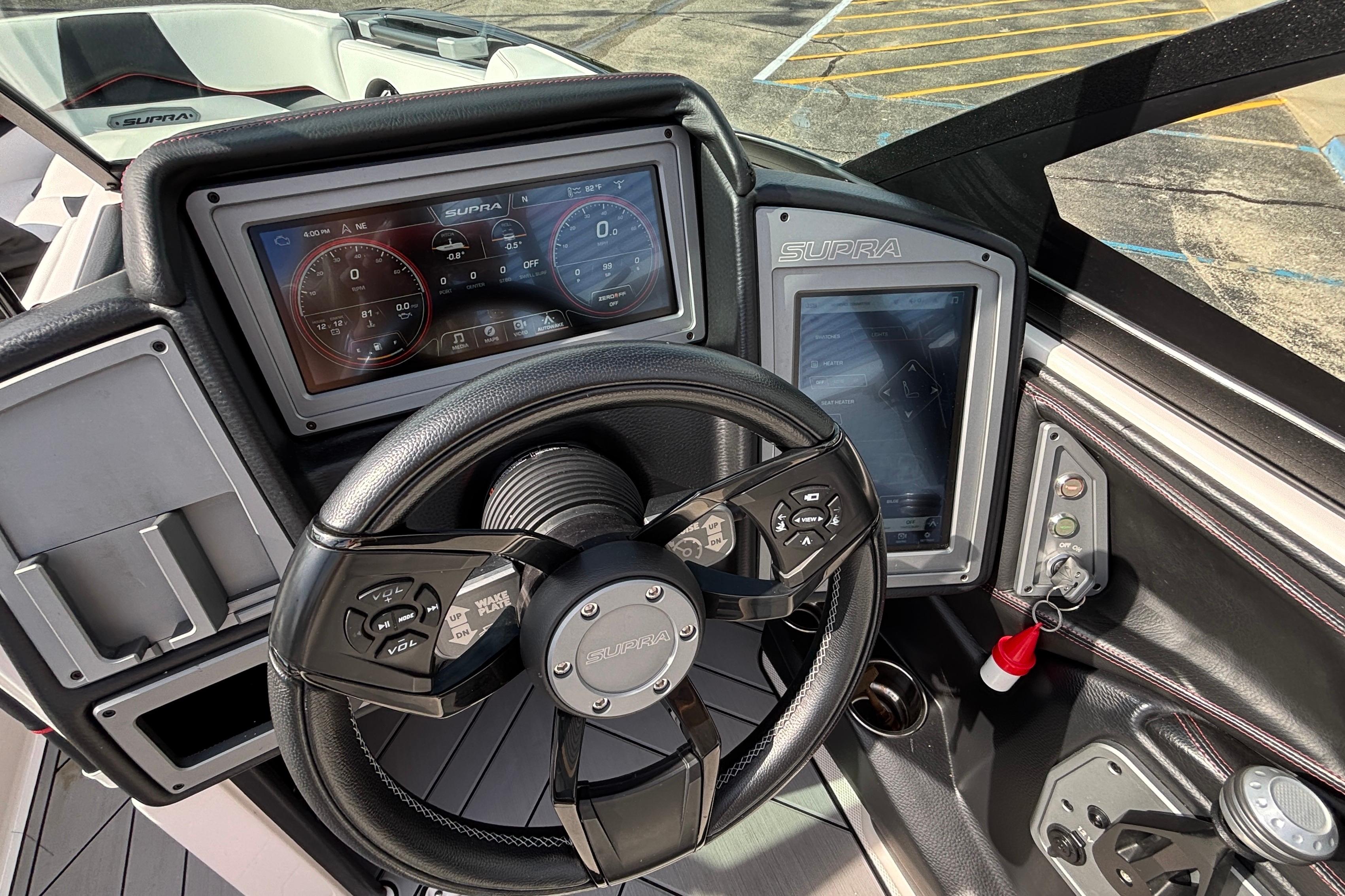 2019 Supra SL 450 boat dashboard with advanced digital controls and steering wheel.