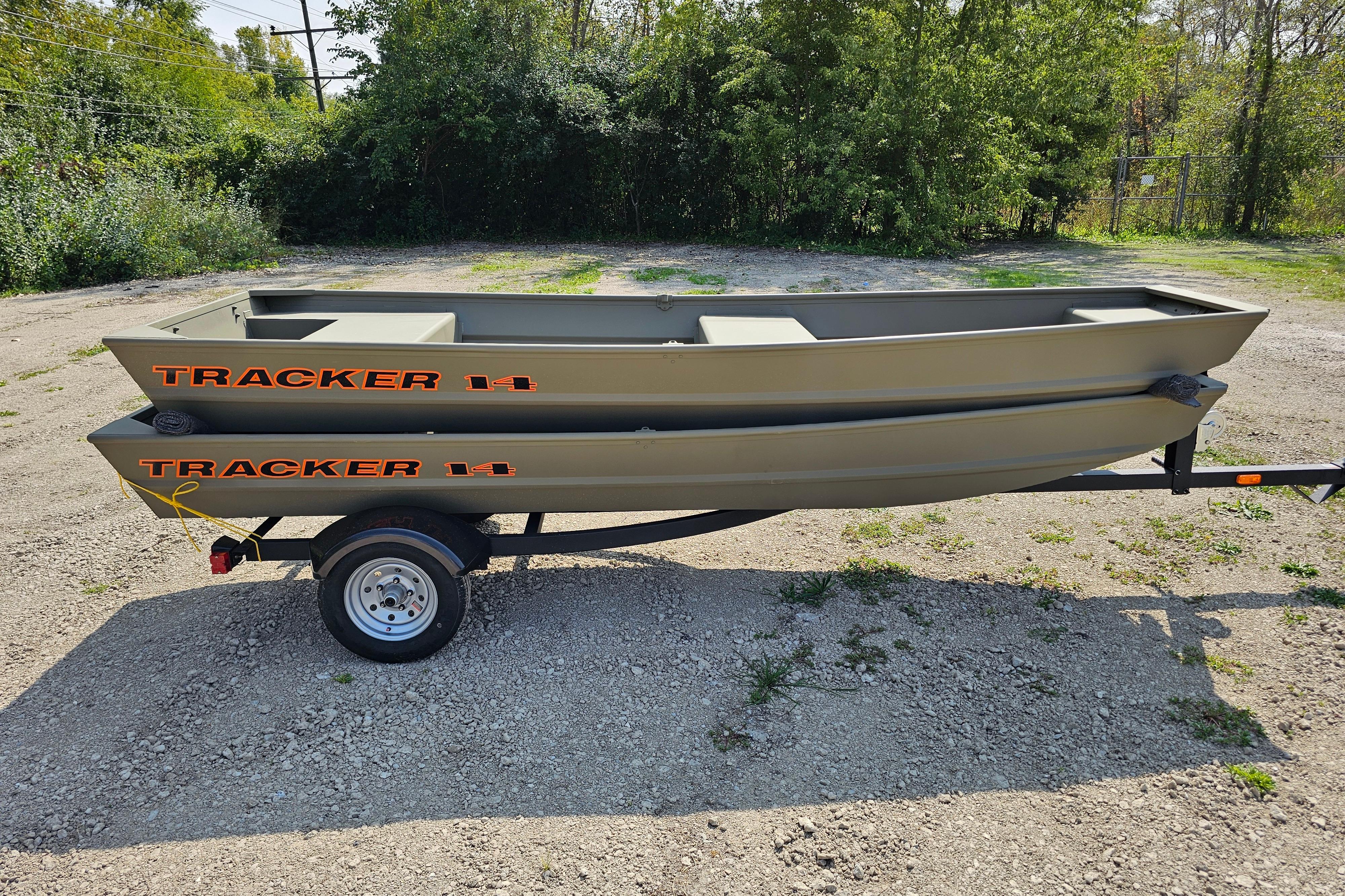 2026 Tracker Grizzly 14 Jon boat on trailer, parked outdoors on gravel.