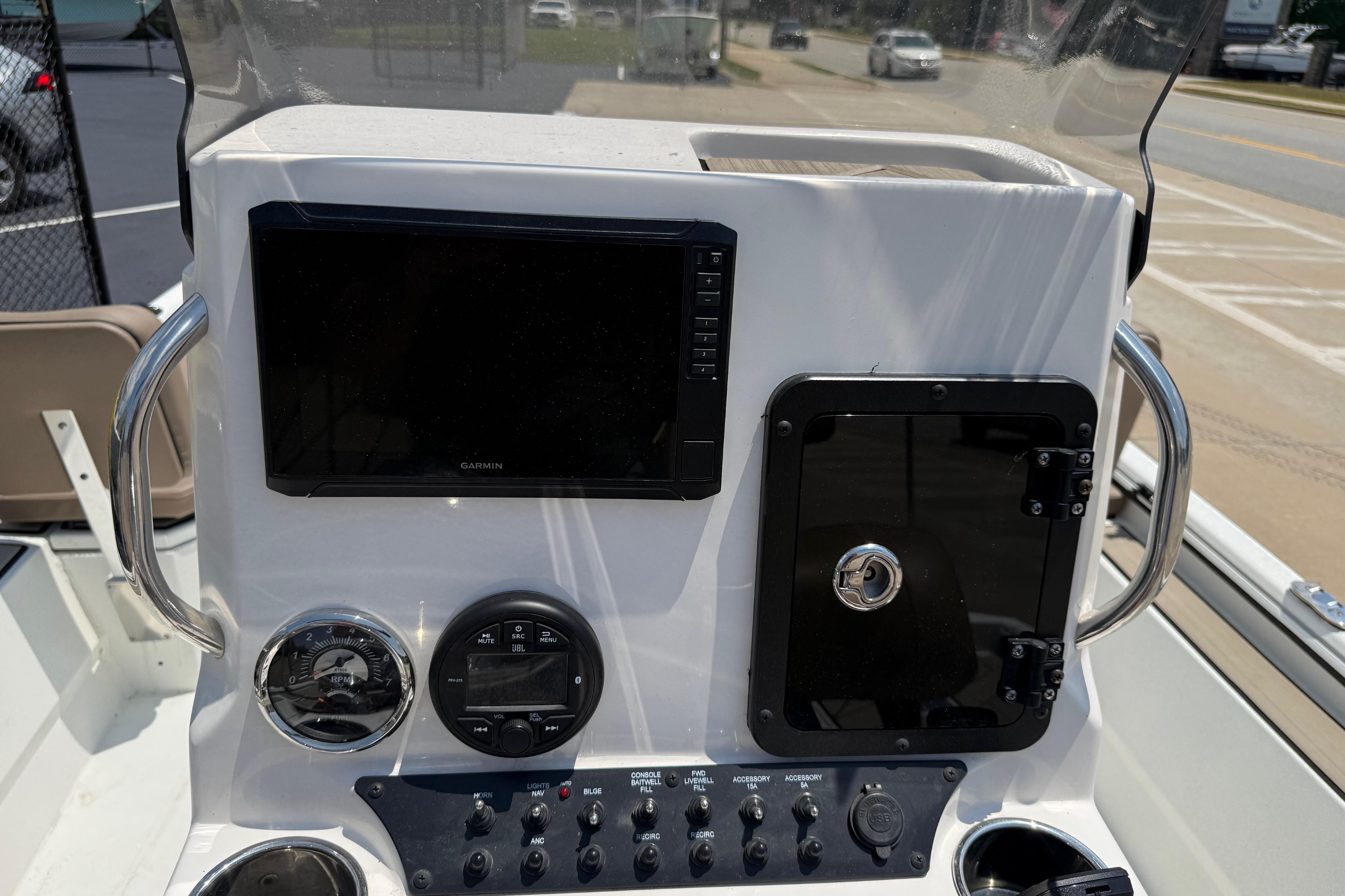 Control panel of 2025 Avid 22 Recon boat with Garmin display and switches.