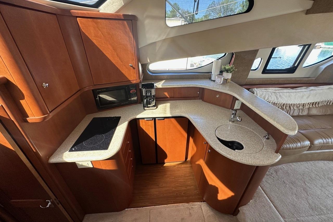 Luxurious 2005 Silverton 38 Sport Bridge yacht interior kitchen with modern amenities.