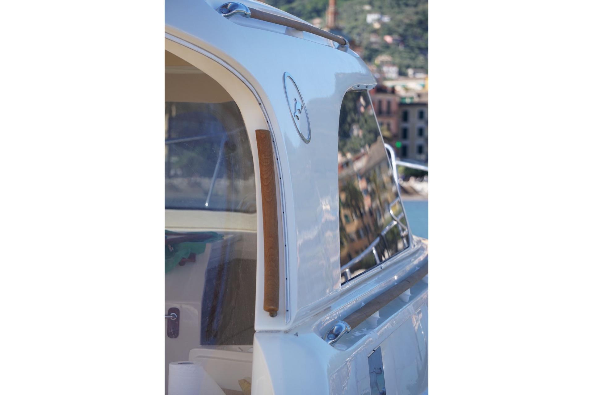 Close-up of a 2005 MOCHI 44 Dolphin yacht exterior with scenic reflections.