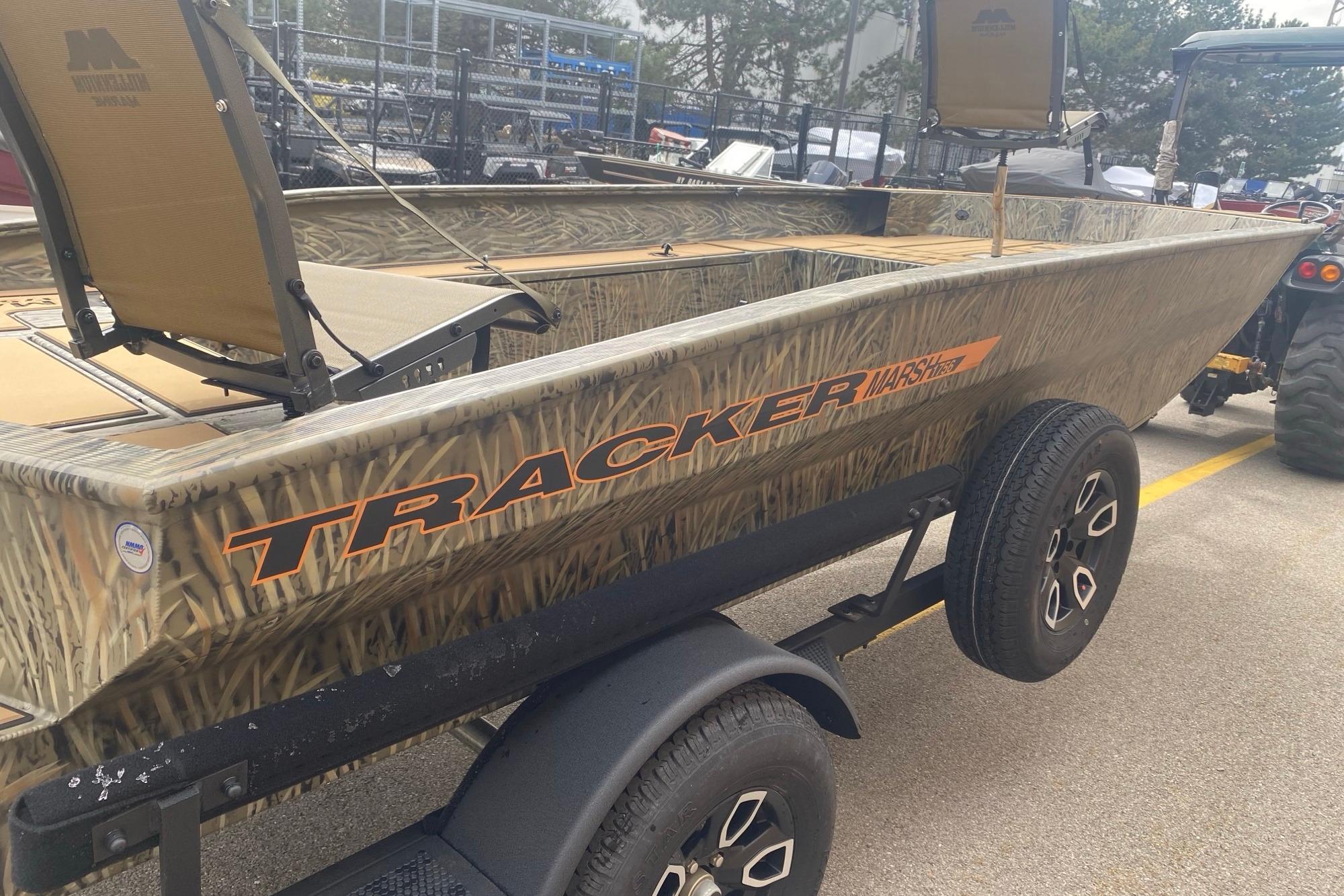 2026 Tracker Grizzly 1756 T Marsh boat on trailer, camo design, outdoor setting.