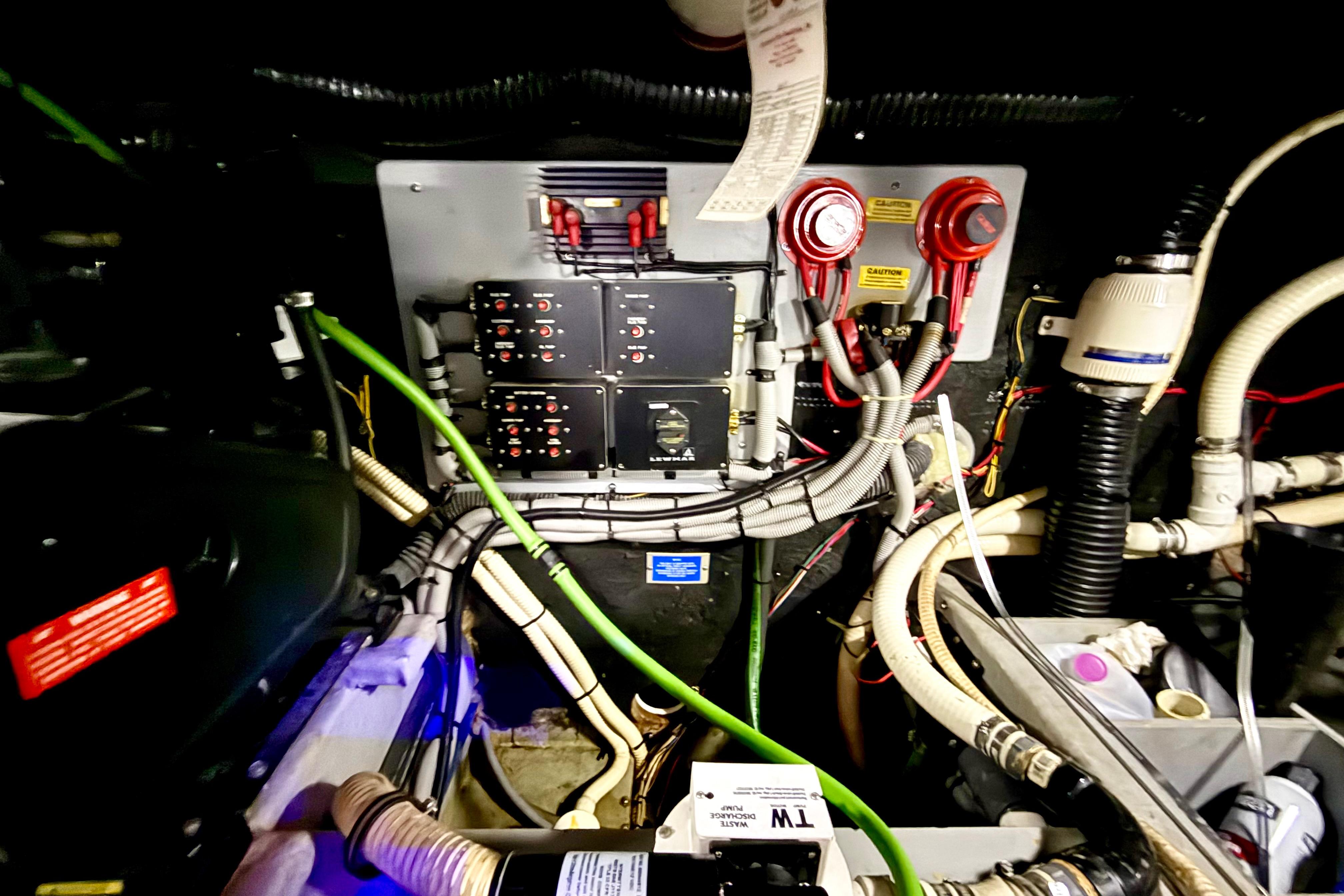 Engine room of 1989 Sea Ray 380 Aft Cabin with wiring and control panels.