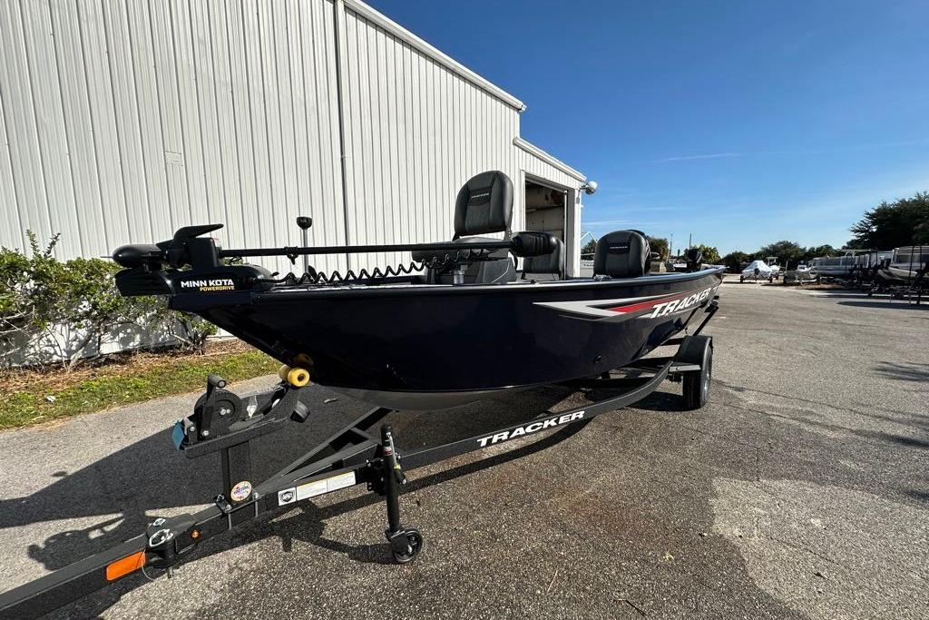 2026 Tracker Pro Guide V-16 SC boat on trailer, parked outdoors.