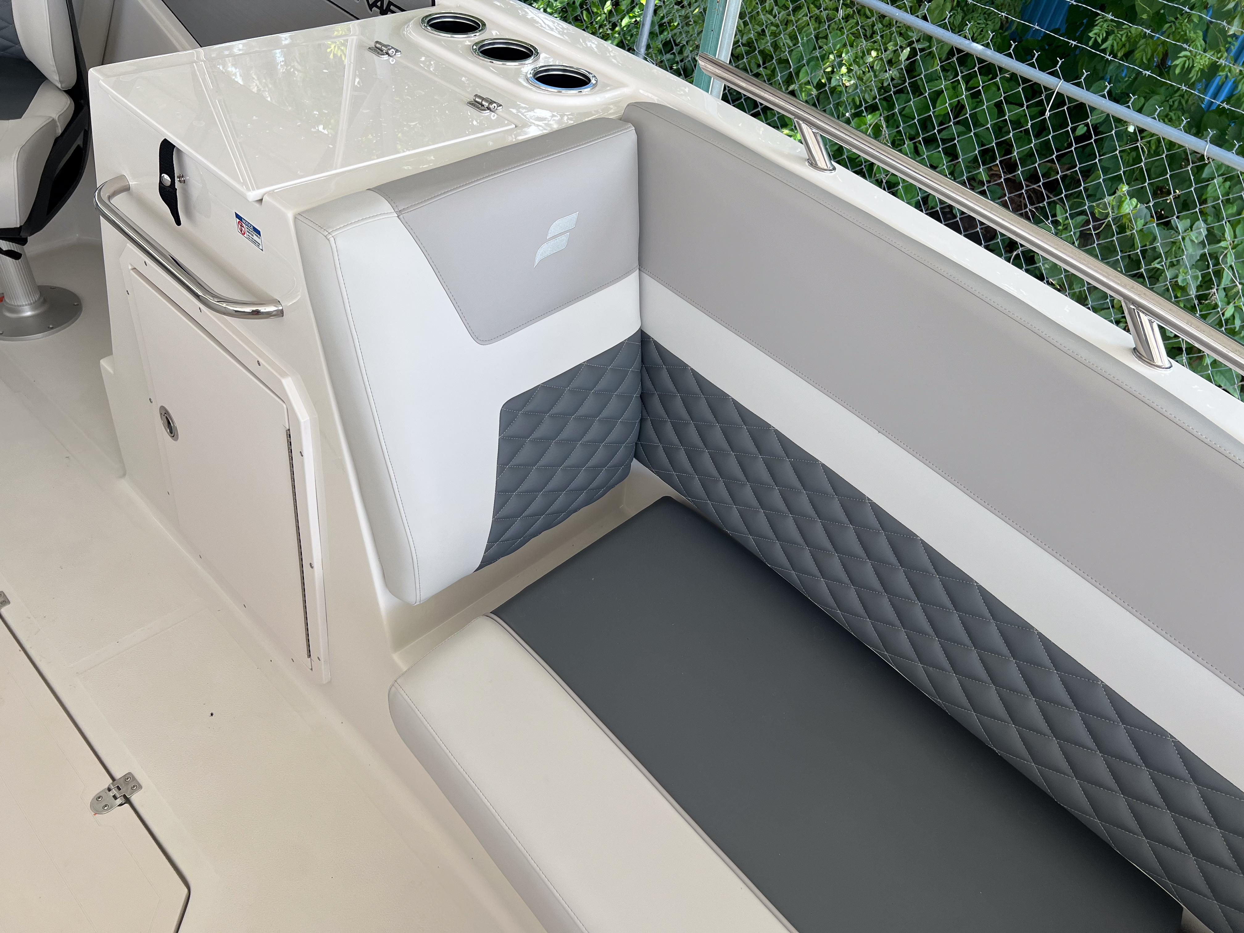 2026 Starcraft SVX 231 OB boat interior with quilted seating and storage compartment.