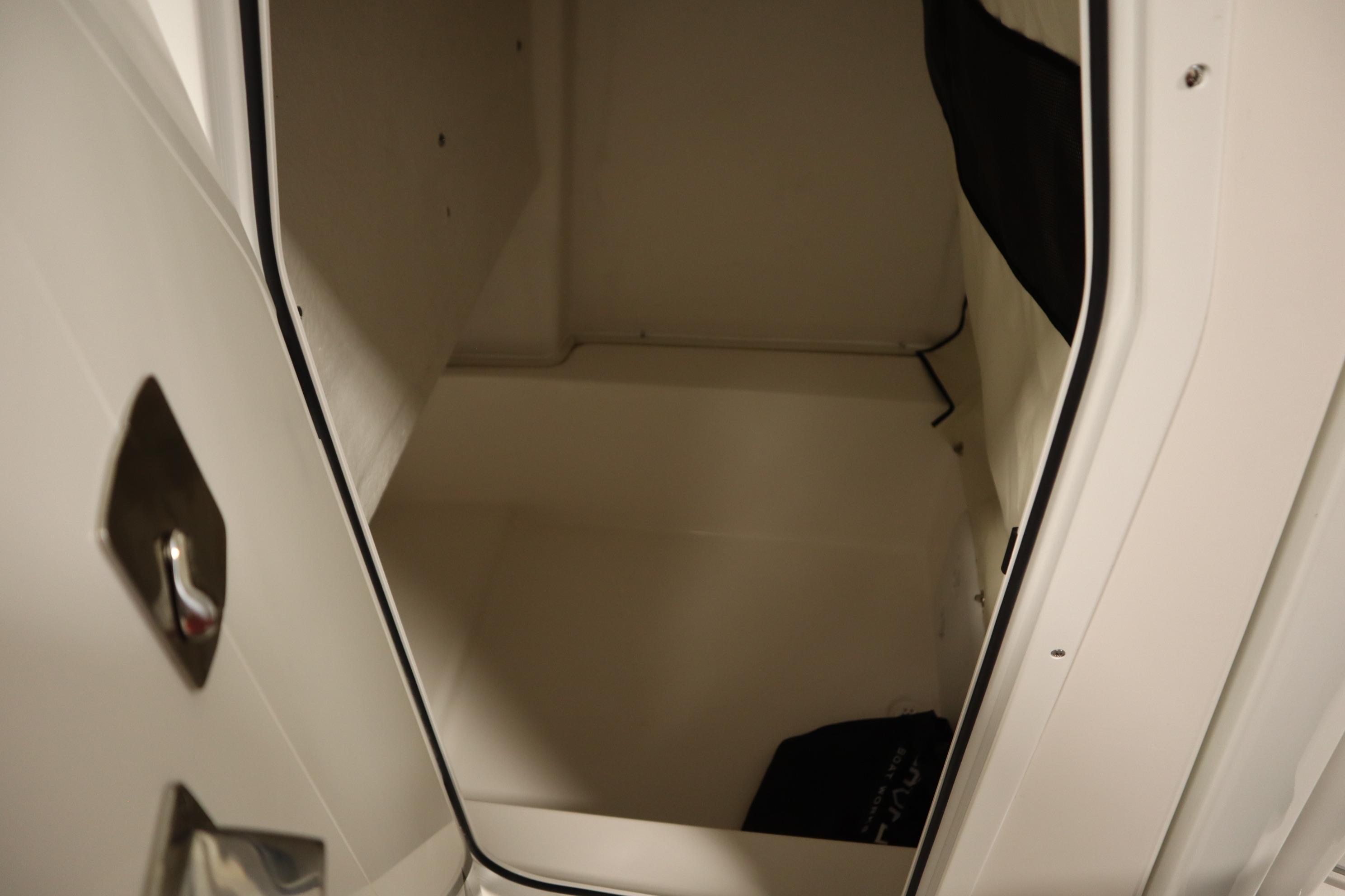 2026 Sea Fox 228 Commander interior storage compartment, open door view.