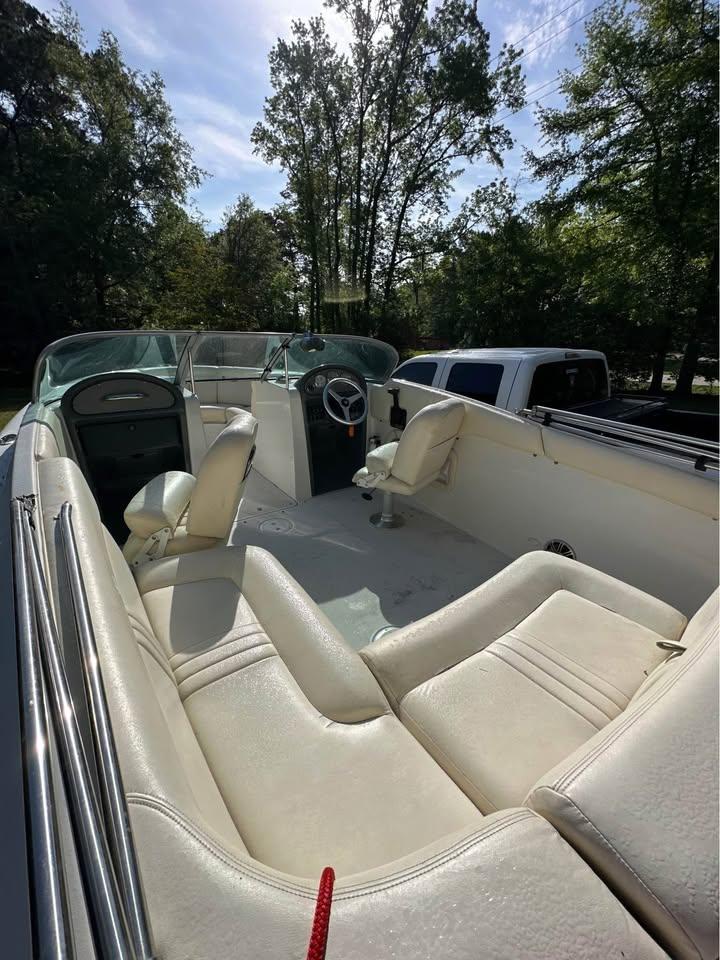 2001 Chris-Craft Launch 22 boat interior with white seating and steering wheel.