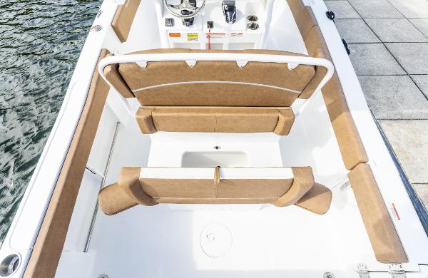 2025 Sea Hunt Ultra 235 SE boat interior with tan seating and steering console.