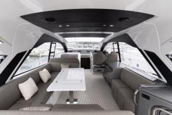 Luxurious interior of 2019 Azimut Atlantis 51 yacht with modern seating and dining area.