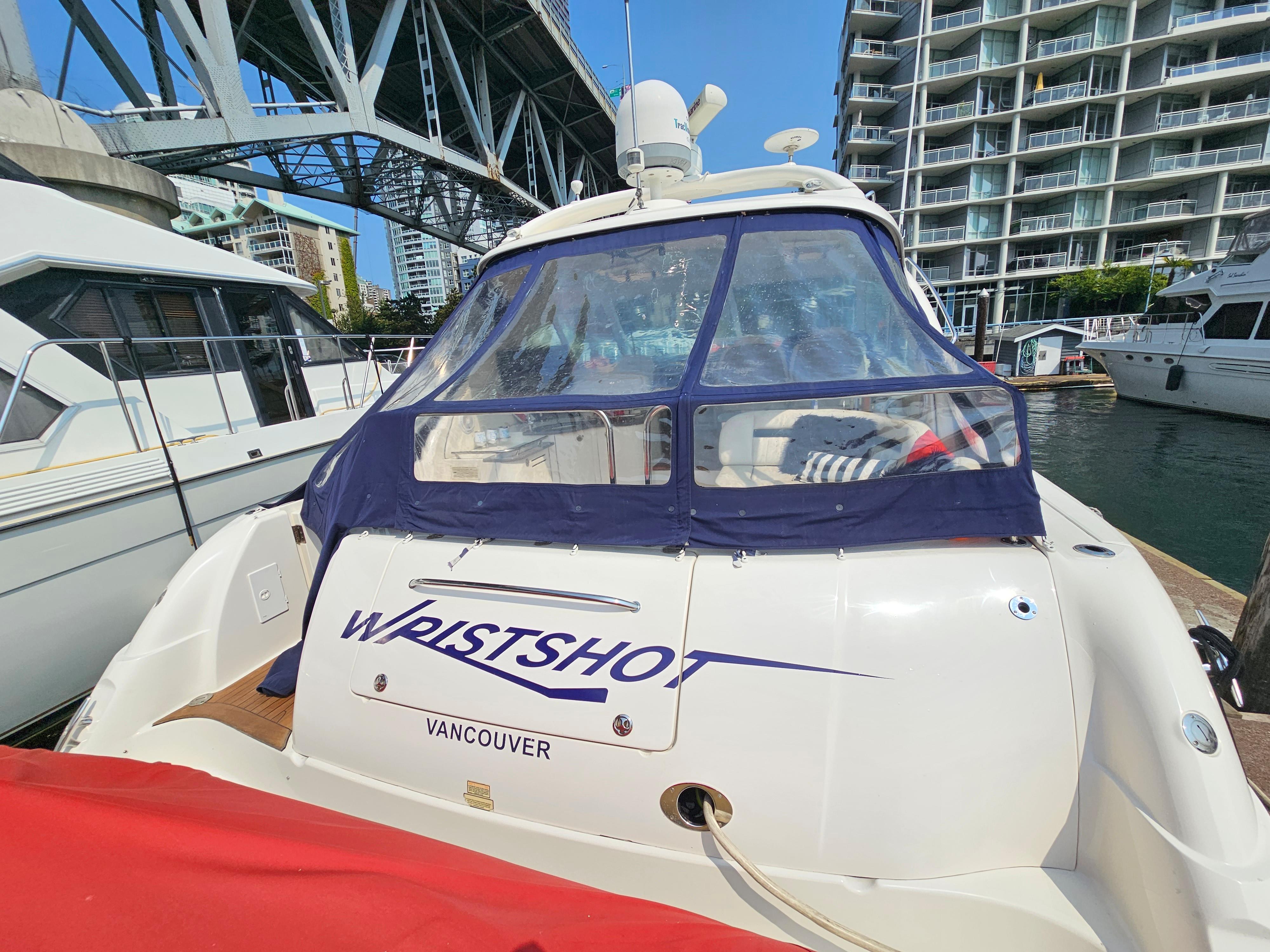 2005 Sea Ray 48 Sundancer yacht docked in Vancouver marina, under bridge.