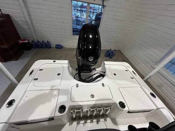 2025 Sea Pro 210 Bay boat with outboard motor in a garage setting.