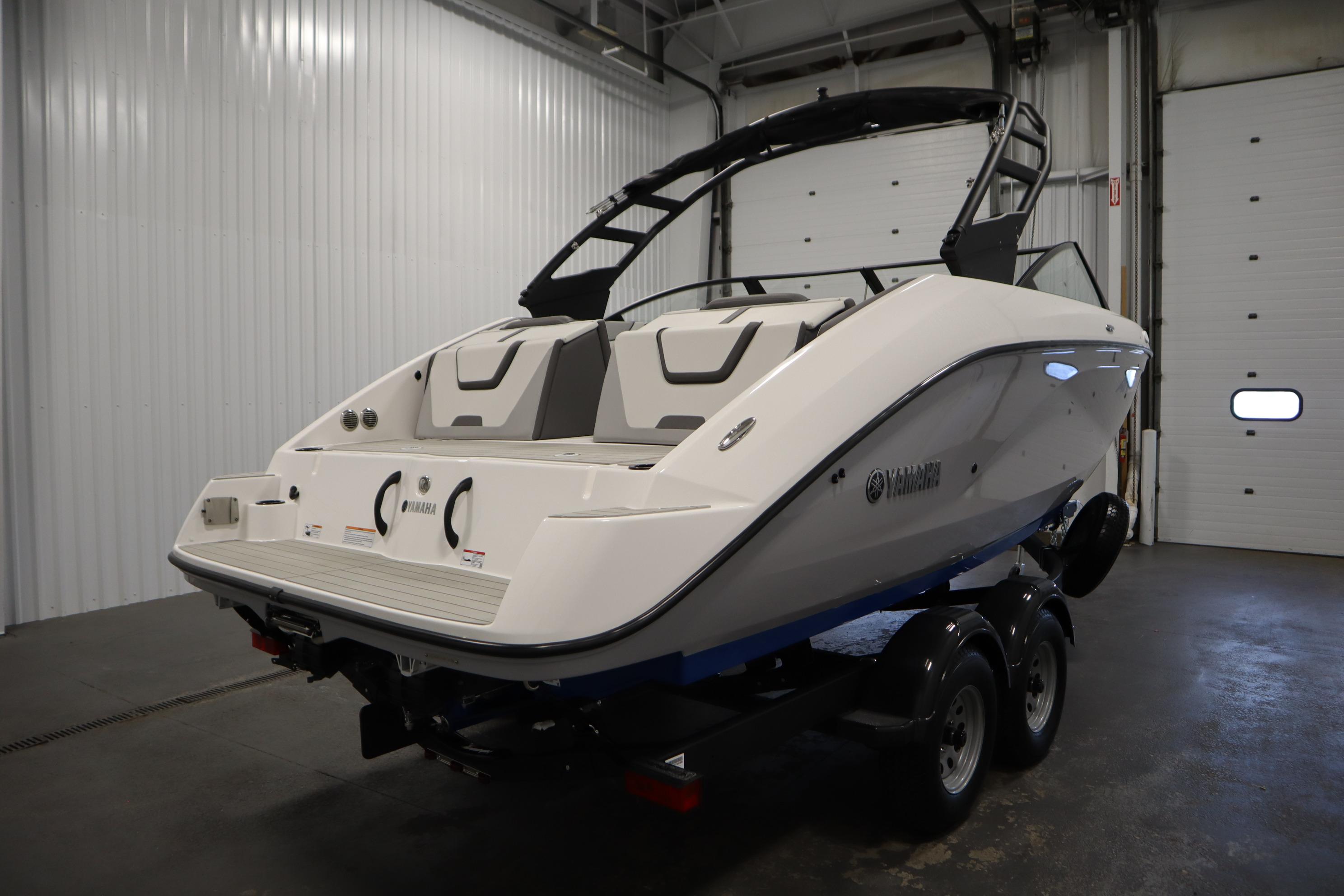 2026 Yamaha Boats AR220 in a showroom, showcasing sleek design and modern features.