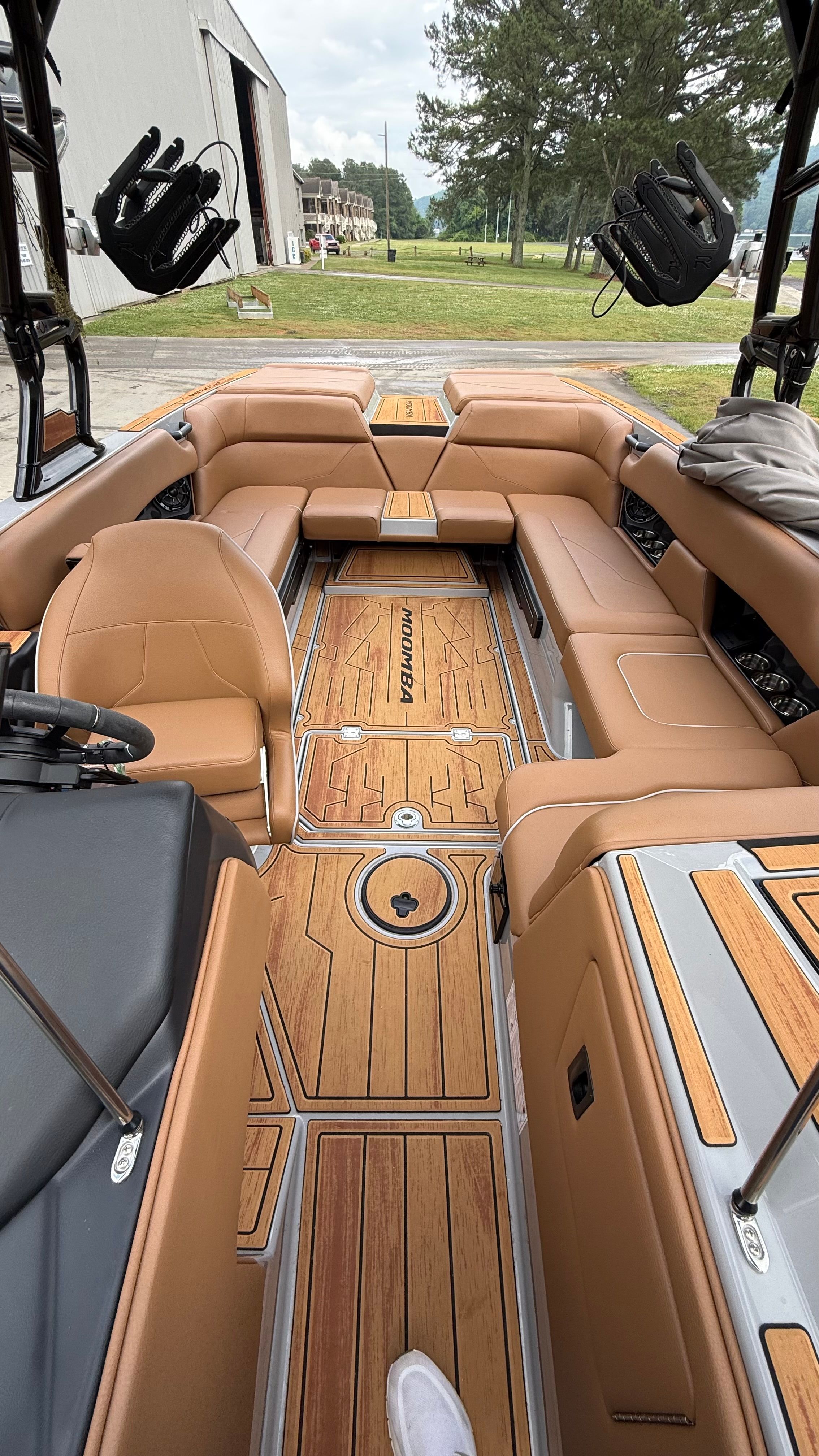 Interior of a 2025 Malibu Mojo with brown leather seats and wooden flooring.
