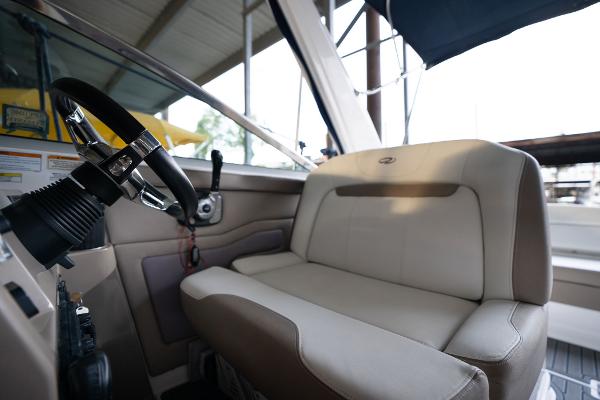 2016 Regal 28 Express boat interior with steering wheel and beige seating.