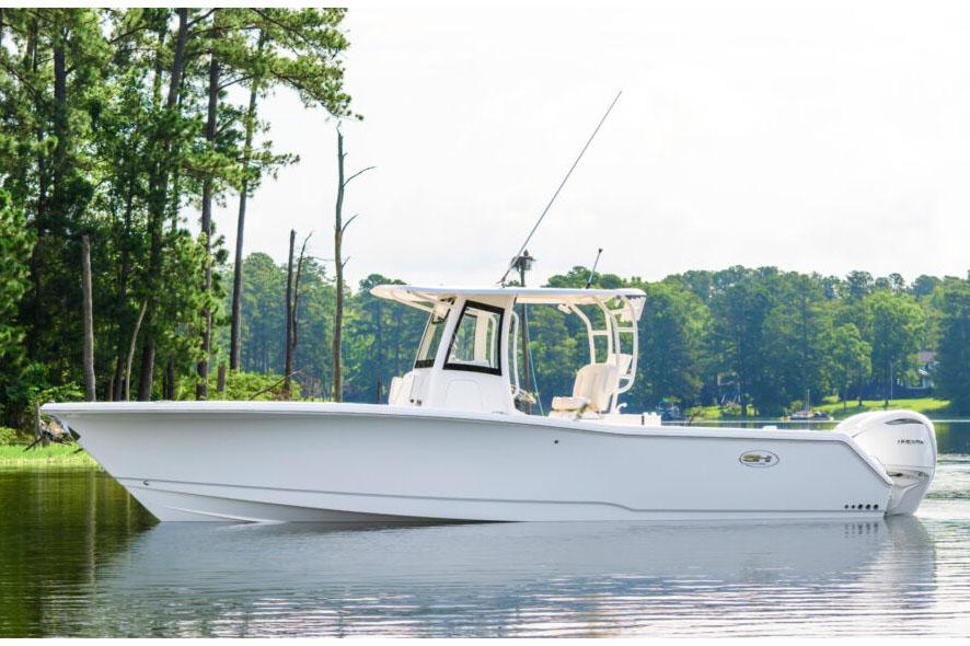 Manufacturer Provided Image: 2026 Sea Hunt Gamefish 30 Coffin Box boat on a serene lake with lush greenery.