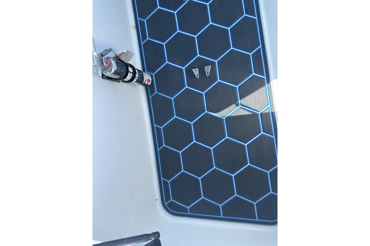 2018 Wright Performance 420 boat deck with hexagonal pattern and mounted fire extinguisher.