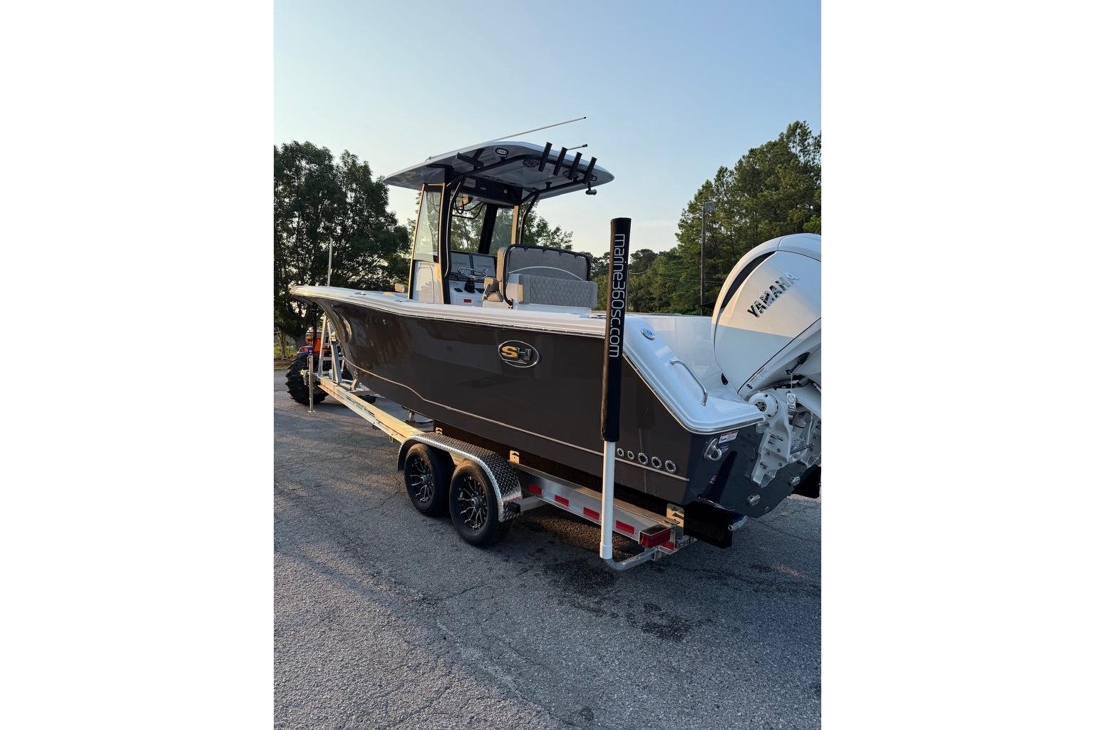 2026 Sea Hunt Gamefish 27 Coffin Box boat on trailer, parked outdoors.