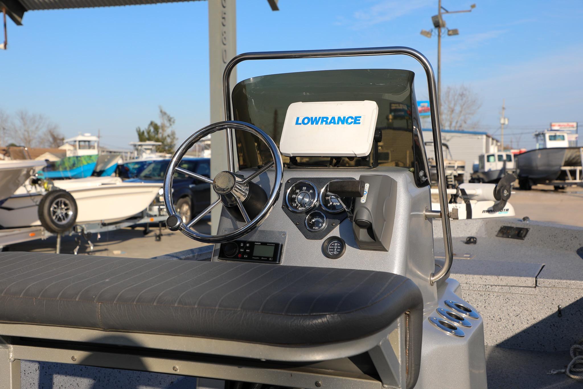 2019 Express 18 boat dashboard with Lowrance navigation system and steering wheel.
