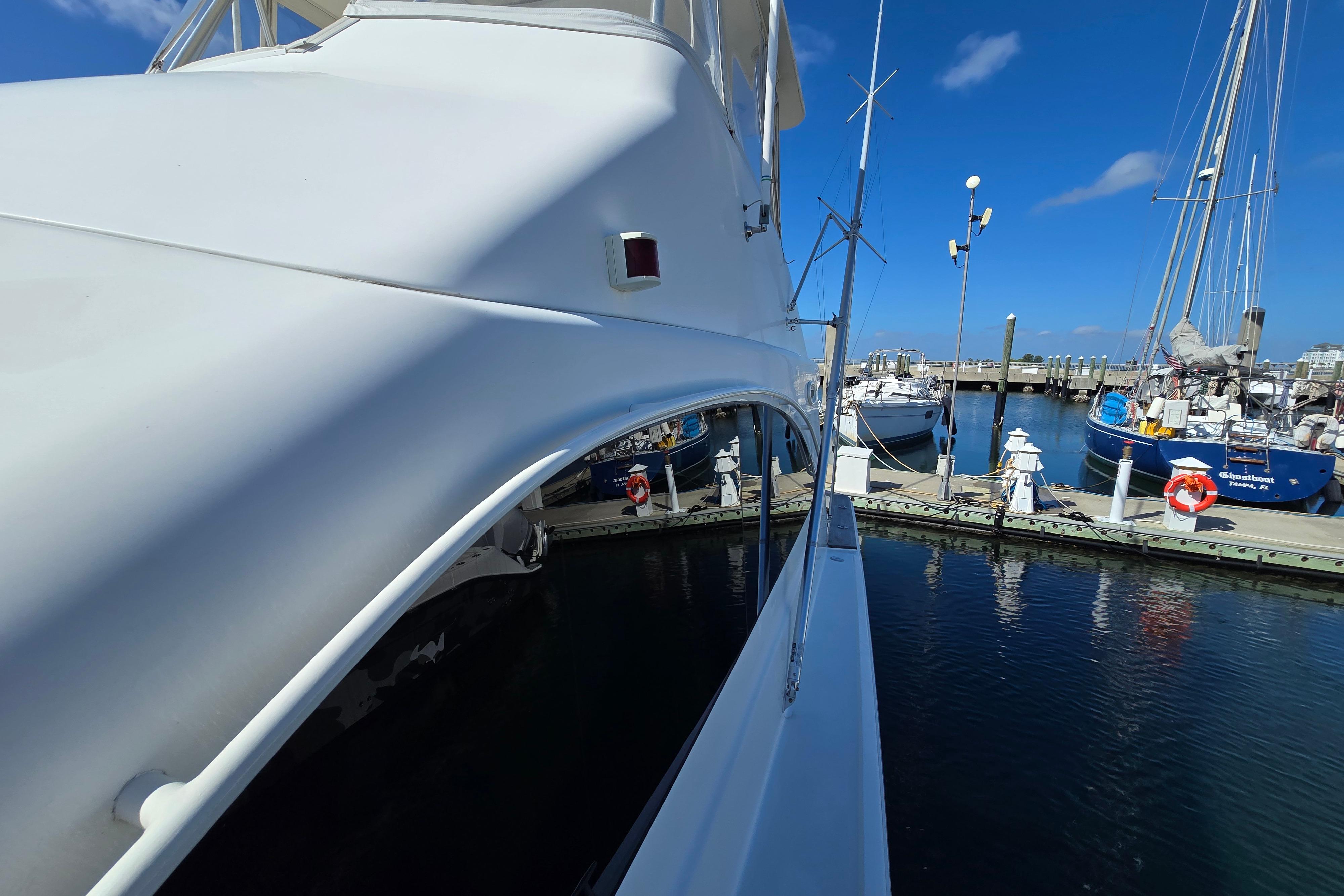 2007 Ocean Yachts 46 Super Sport docked at a marina under clear blue skies.