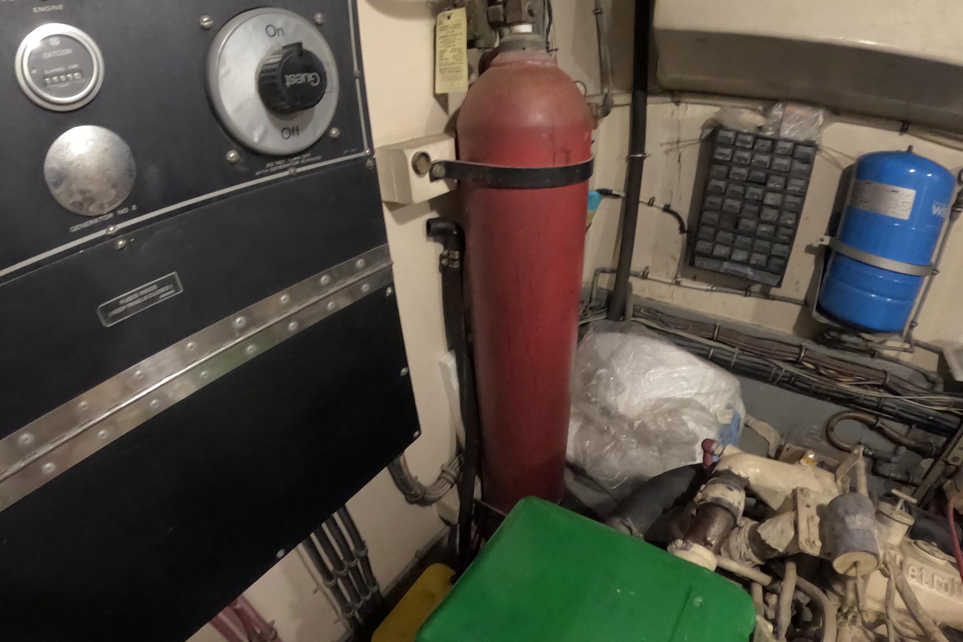 Engine room of 1987 Hatteras 54 Motor Yacht with control panel and equipment.